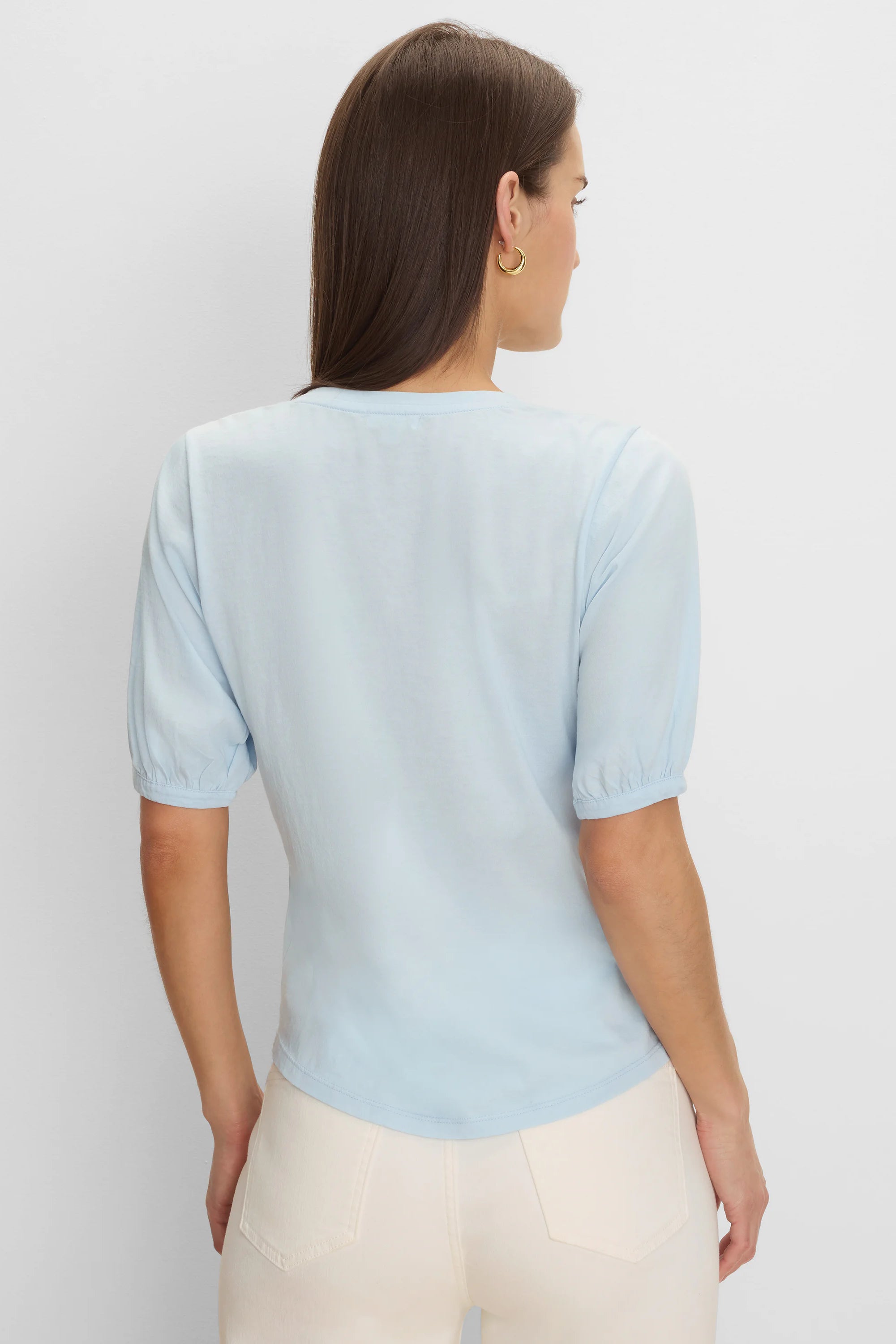 Light blue elbow-sleeve tee, back view on model. Features gathered cuffs and a rounded back neckline.