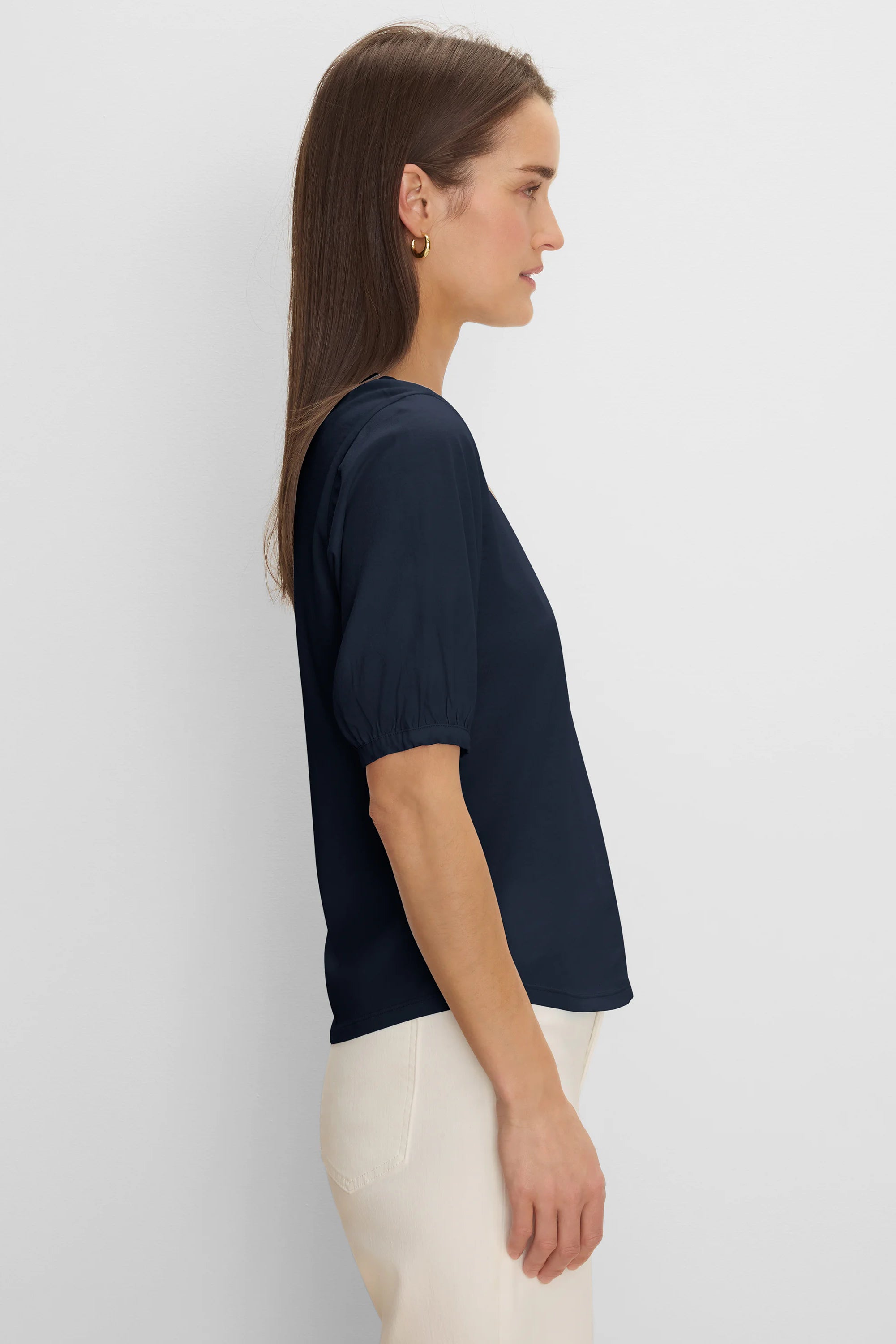 Dark navy V-neck tee with elbow-length sleeves and gathered cuffs, shown on a woman in profile.