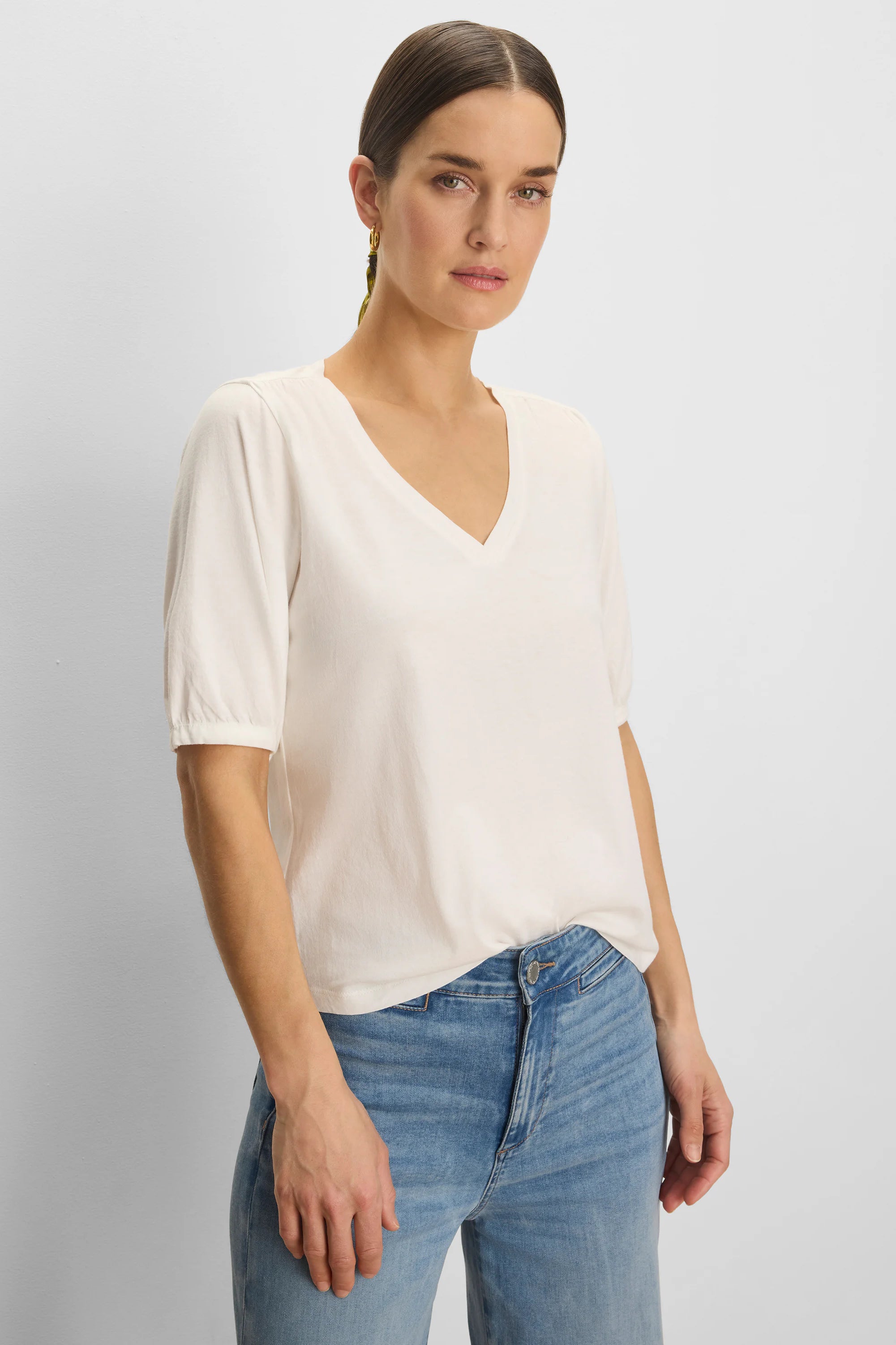 Cream V-neck tee with elbow-length gathered sleeves.