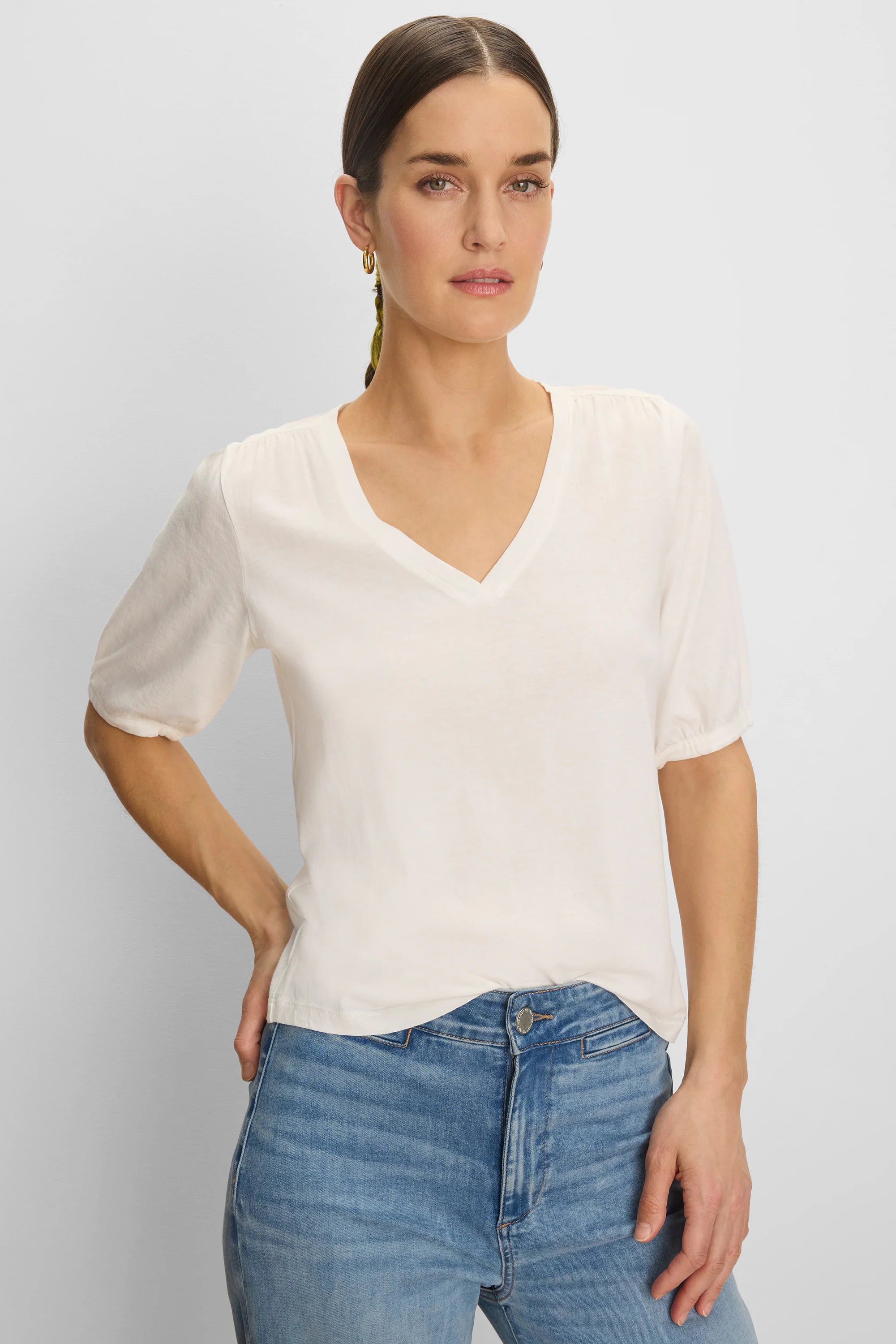 Off-white V-neck tee with elbow-length sleeves, slightly gathered at the shoulders and cuffs.