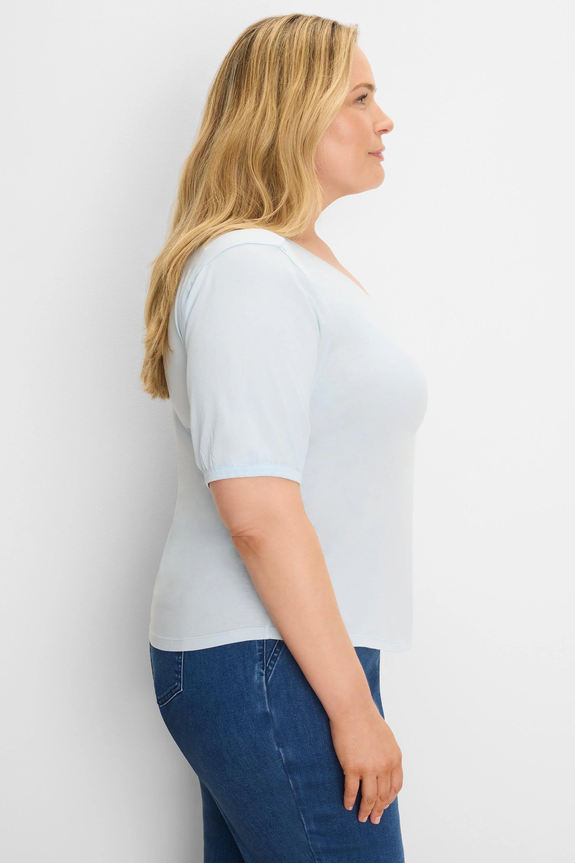 Light blue V-neck tee with elbow-length sleeves.