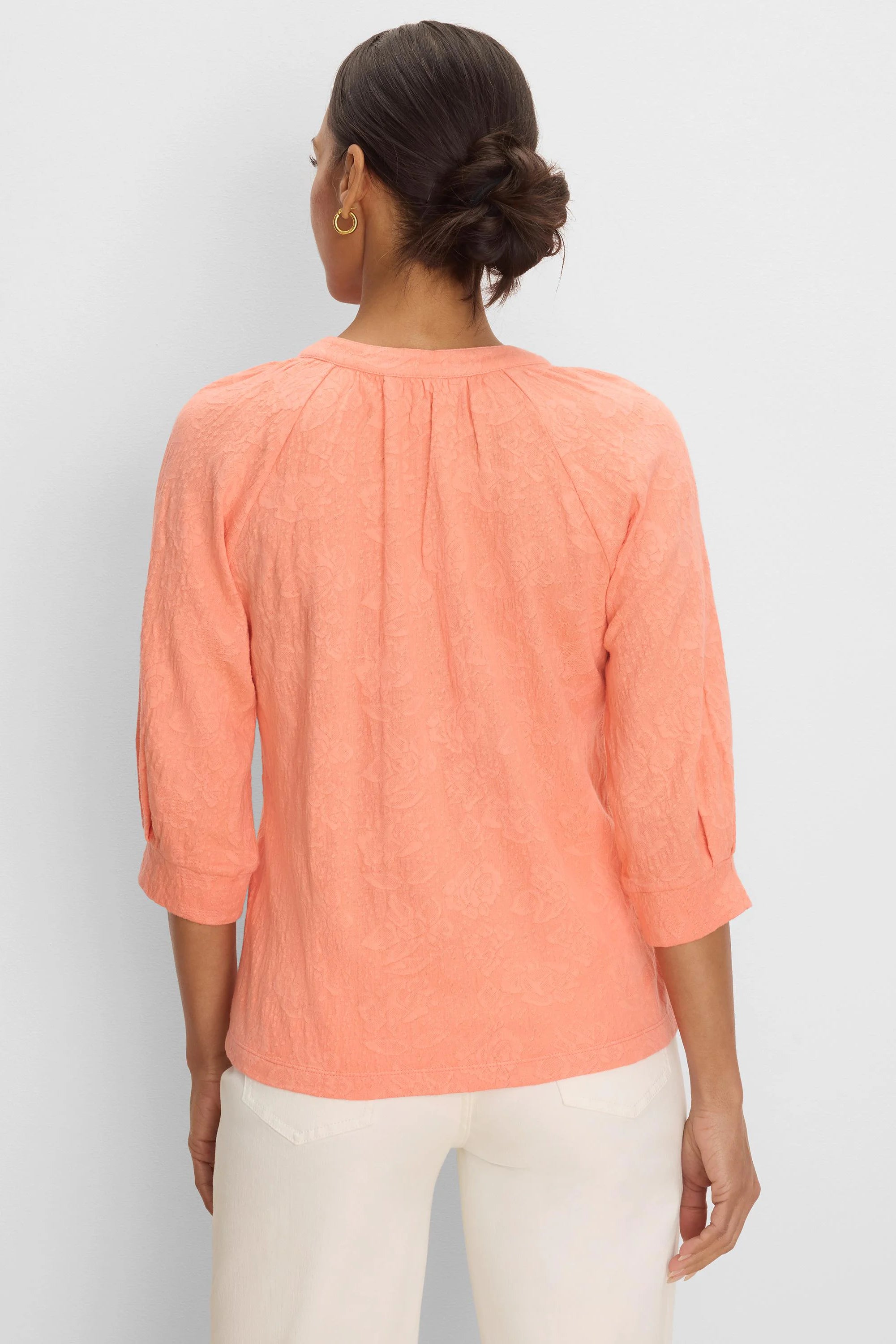 Peach lace knit top with 3/4 sleeves and pleats at the back neckline.