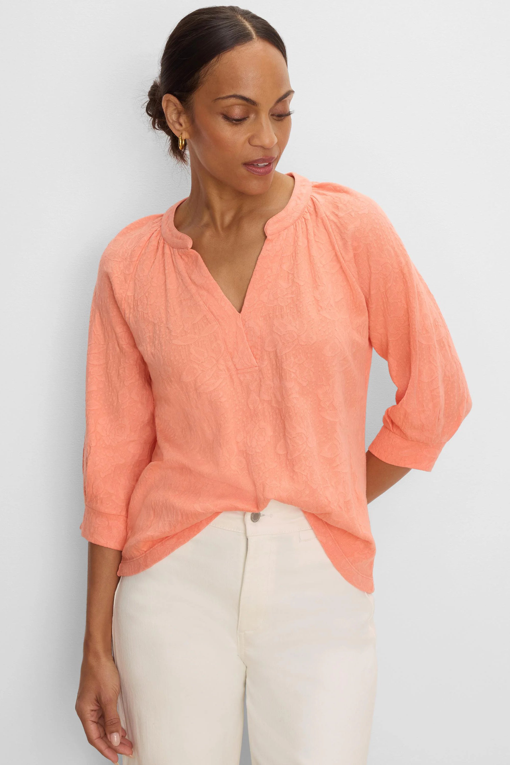 Peach lace knit split neck top with 3/4 sleeves, worn by a model.