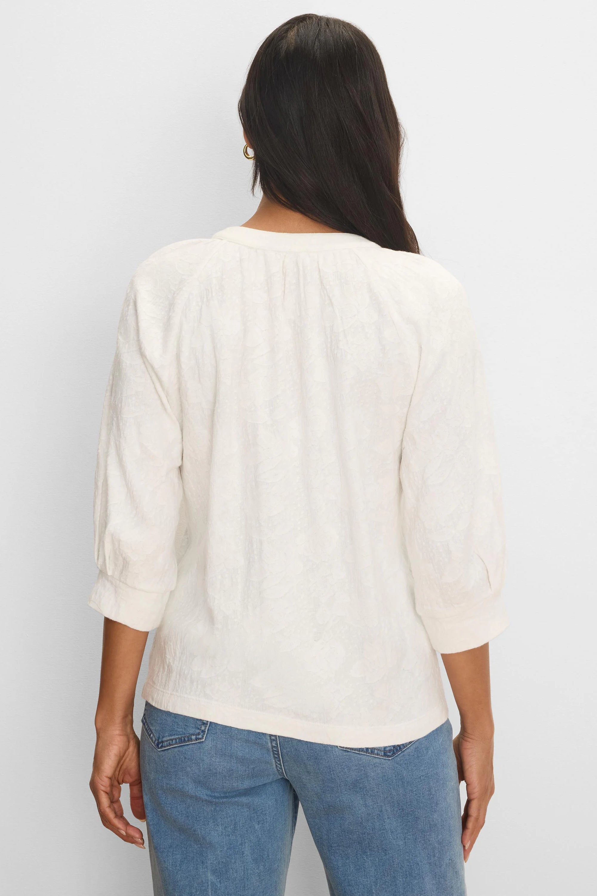 Off-white lace knit top with subtle floral pattern. Back view shows 3/4 cuffed sleeves and gathered neck.