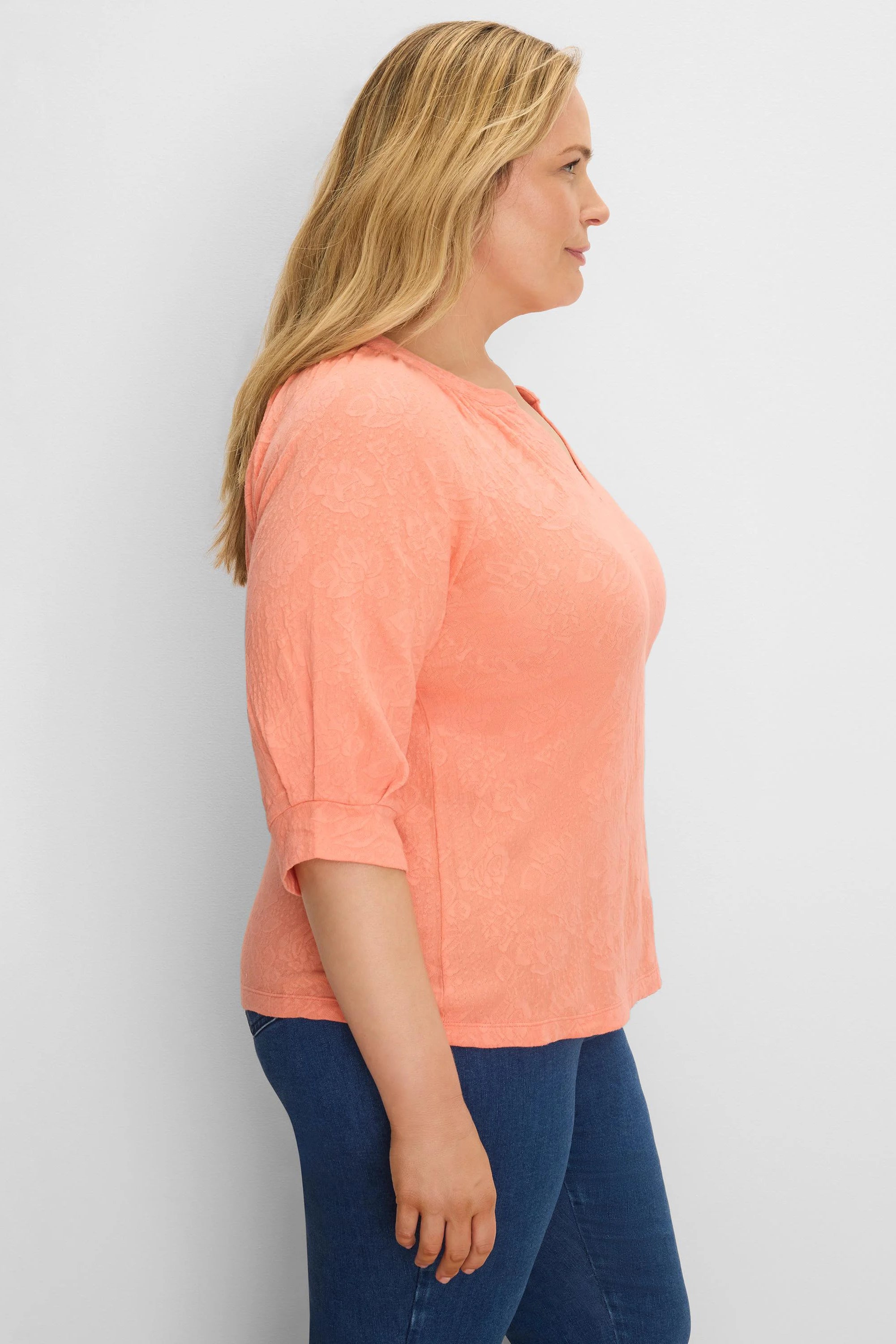 Peach lace knit split neck top with 3/4 sleeves, gathered at the cuff.