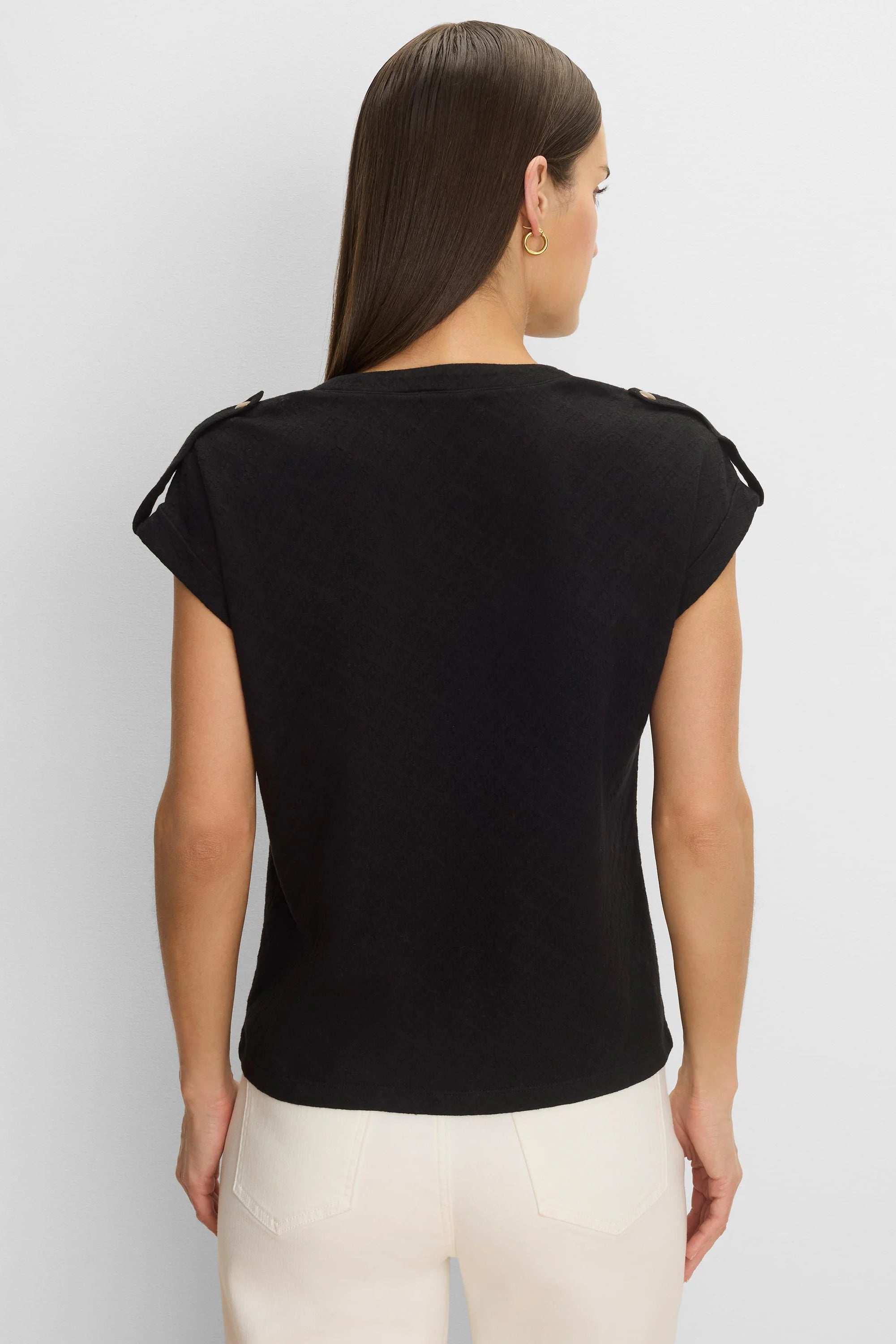 Black lace-knit cap sleeve tee with shoulder tabs and buttons, worn on model's back.