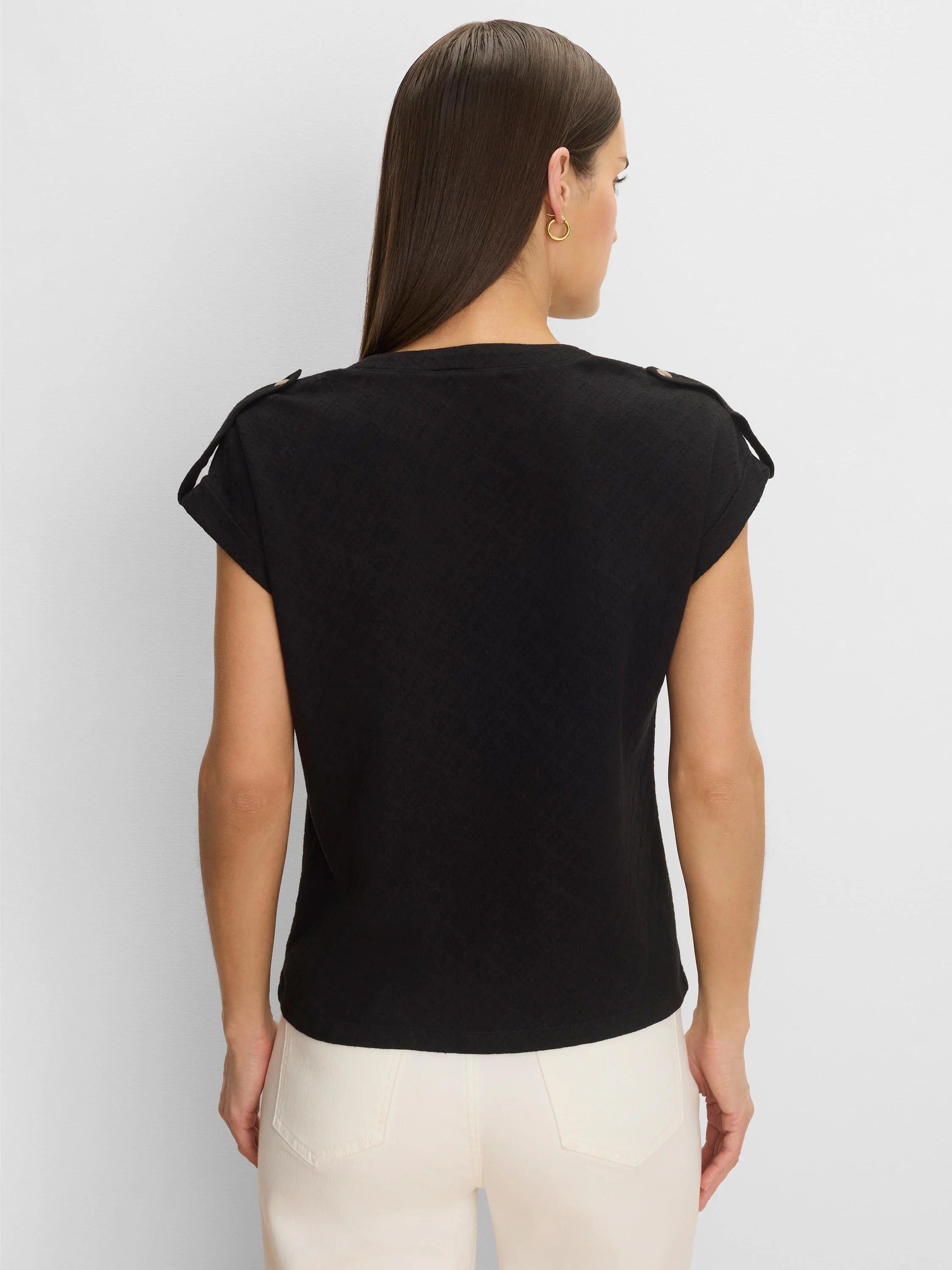 Black lace-knit cap sleeve tee with shoulder tabs and buttons, worn on model's back.