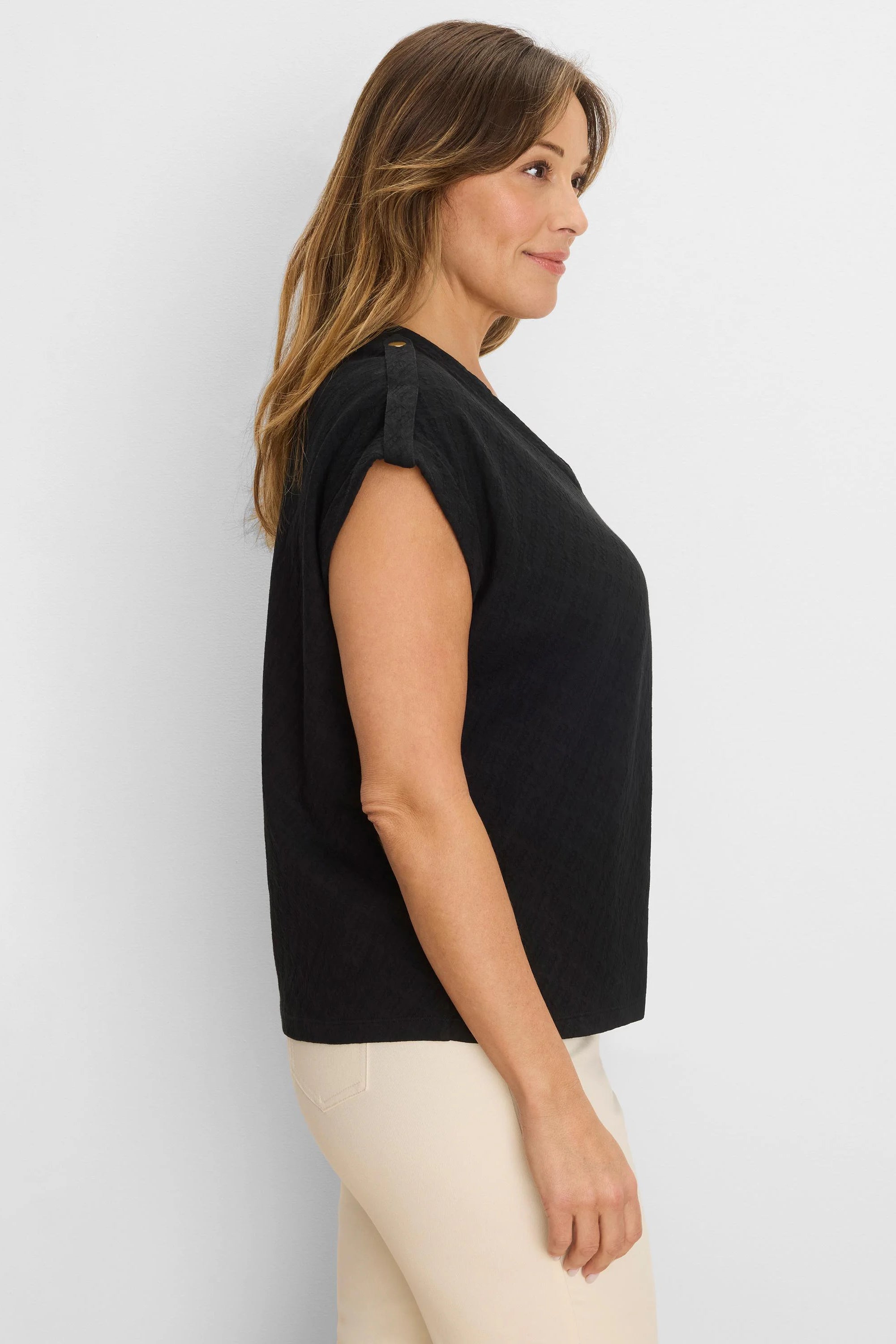 Black lace knit tee with subtle texture. Cap sleeves are rolled up and held by button tabs on shoulders.