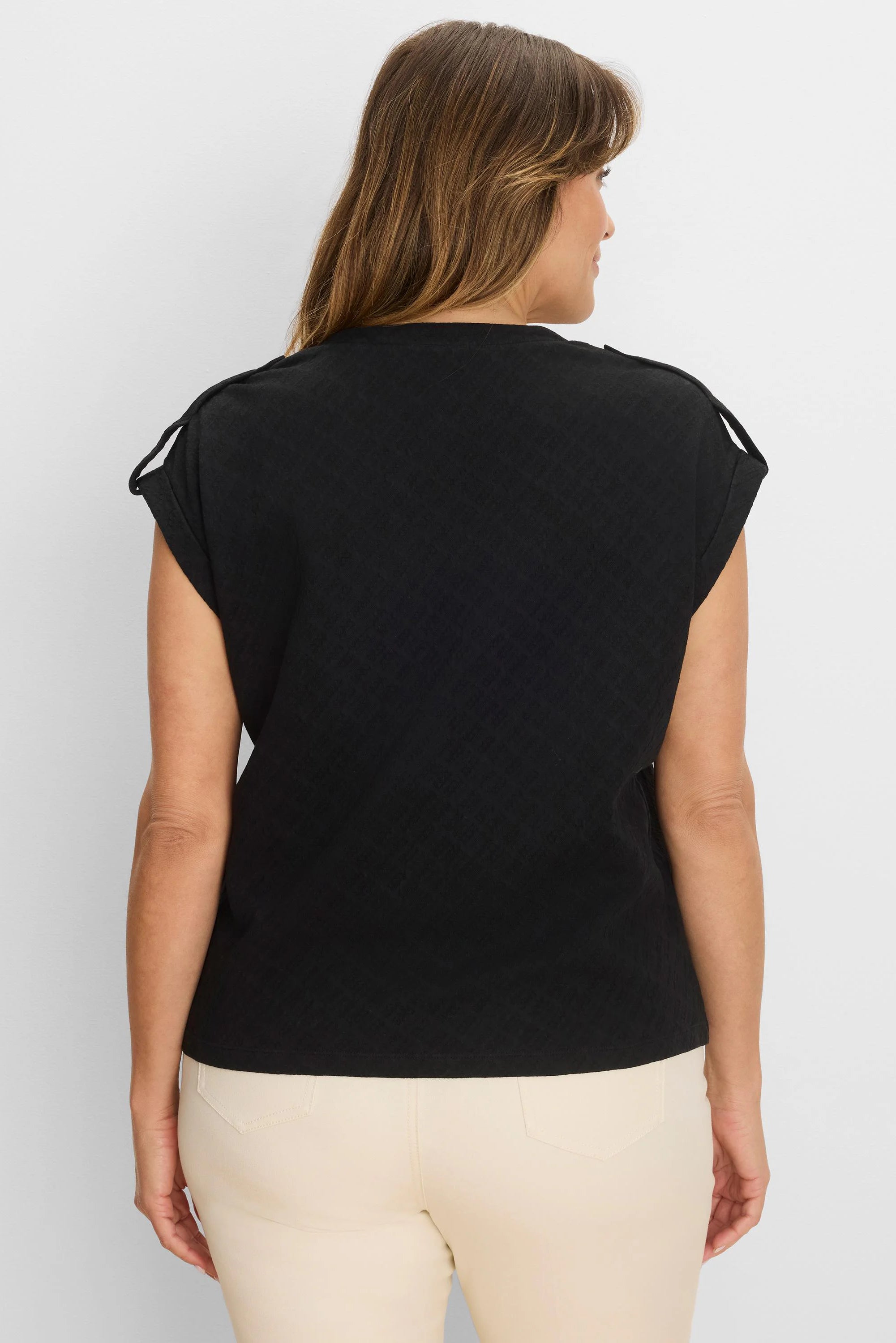 Black lace knit cap sleeve tee with subtle pattern and small shoulder loops.