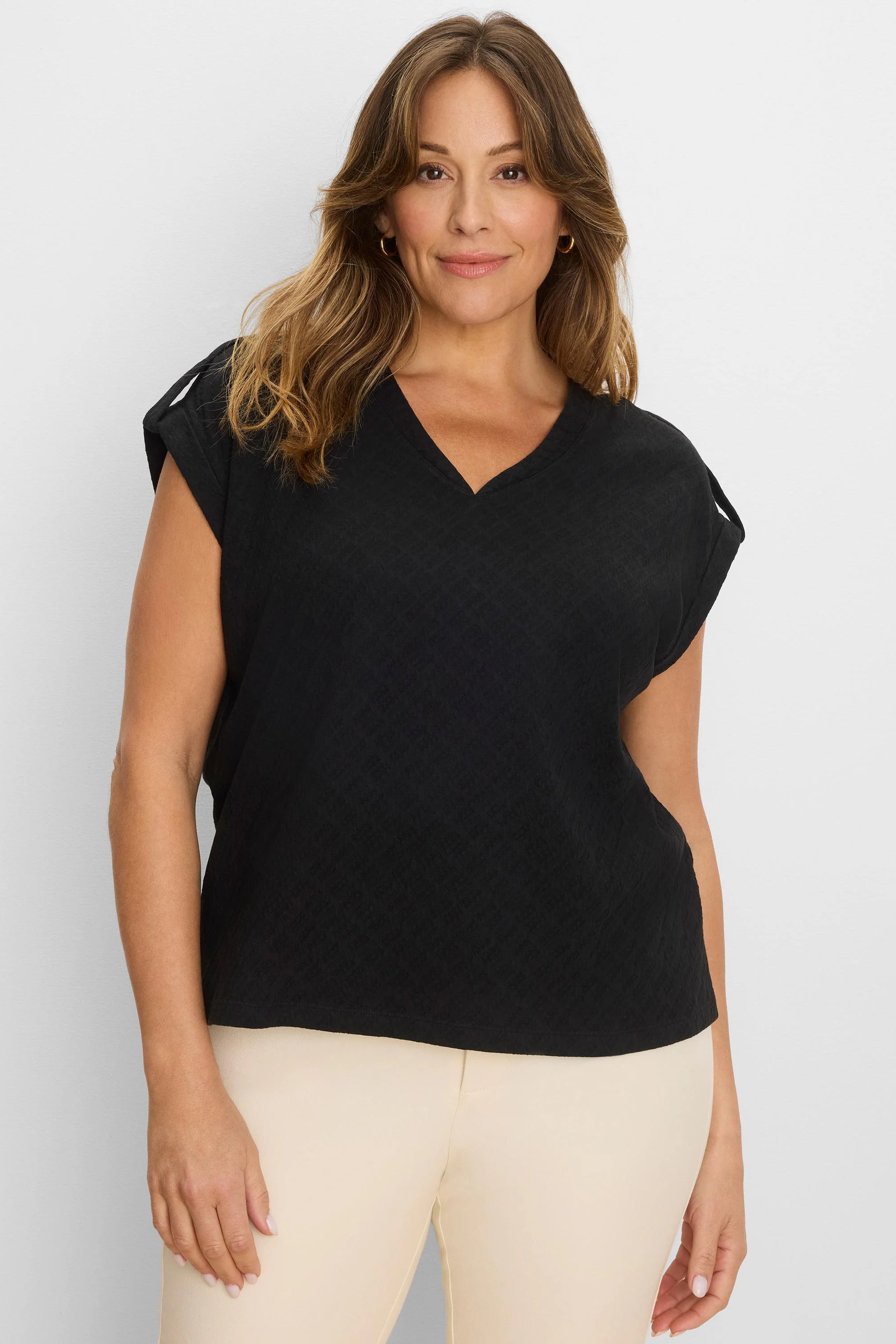 Black V-neck tee with lace knit texture. Features cap sleeves with small shoulder openings.