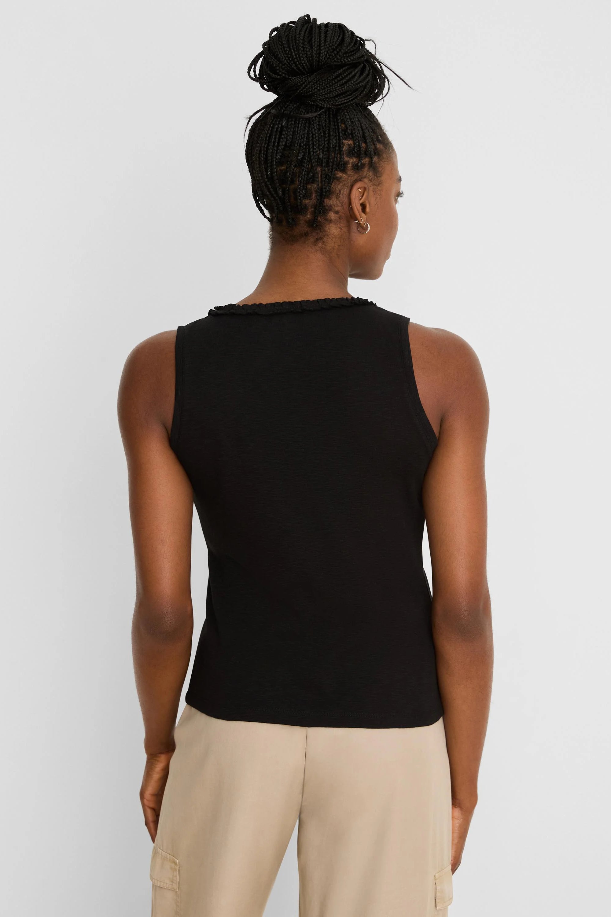 Black cotton slub ruffle neck tank top, viewed from the back on a model.