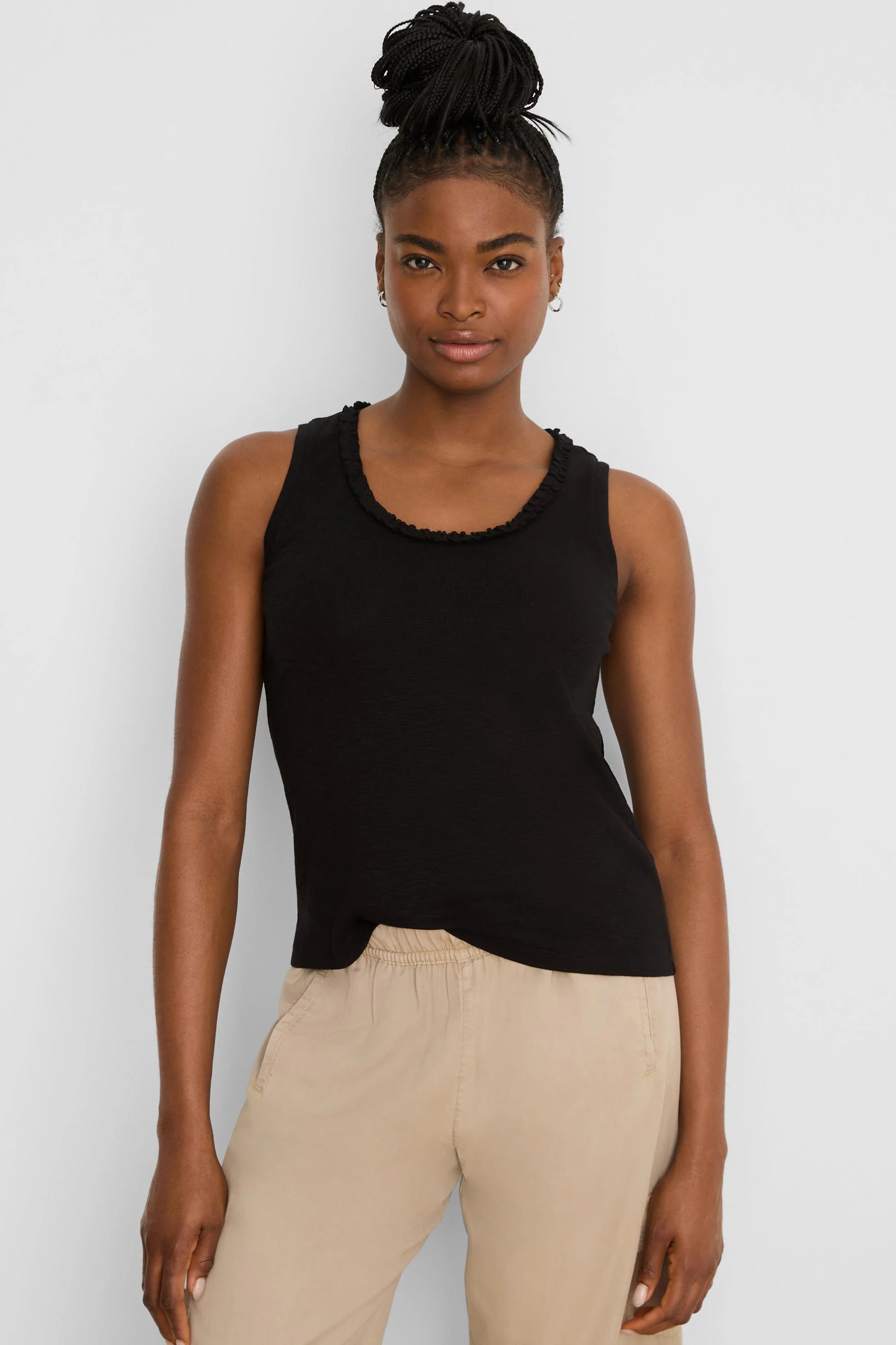 Black cotton slub tank top with a ruffled round neckline.