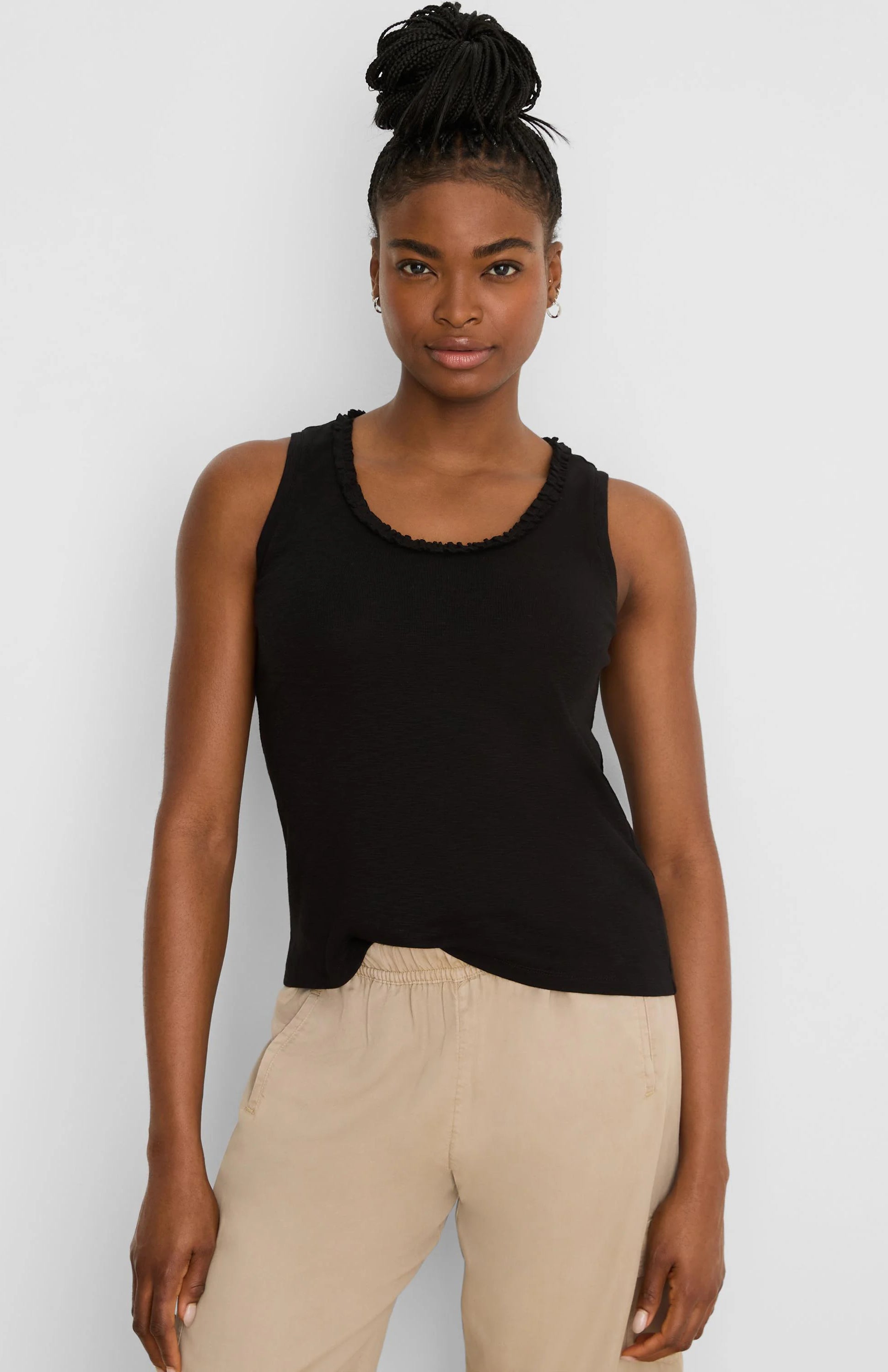 Black cotton slub tank top with a ruffled round neckline.