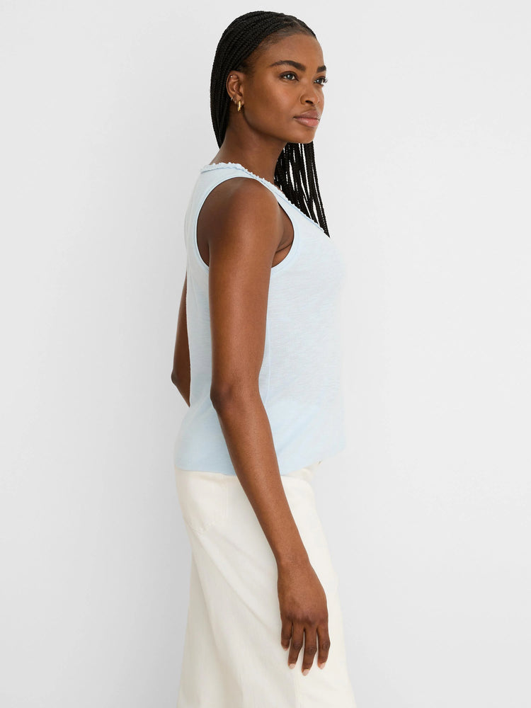 Light blue sleeveless tank with a ruffled neckline and slub cotton texture.