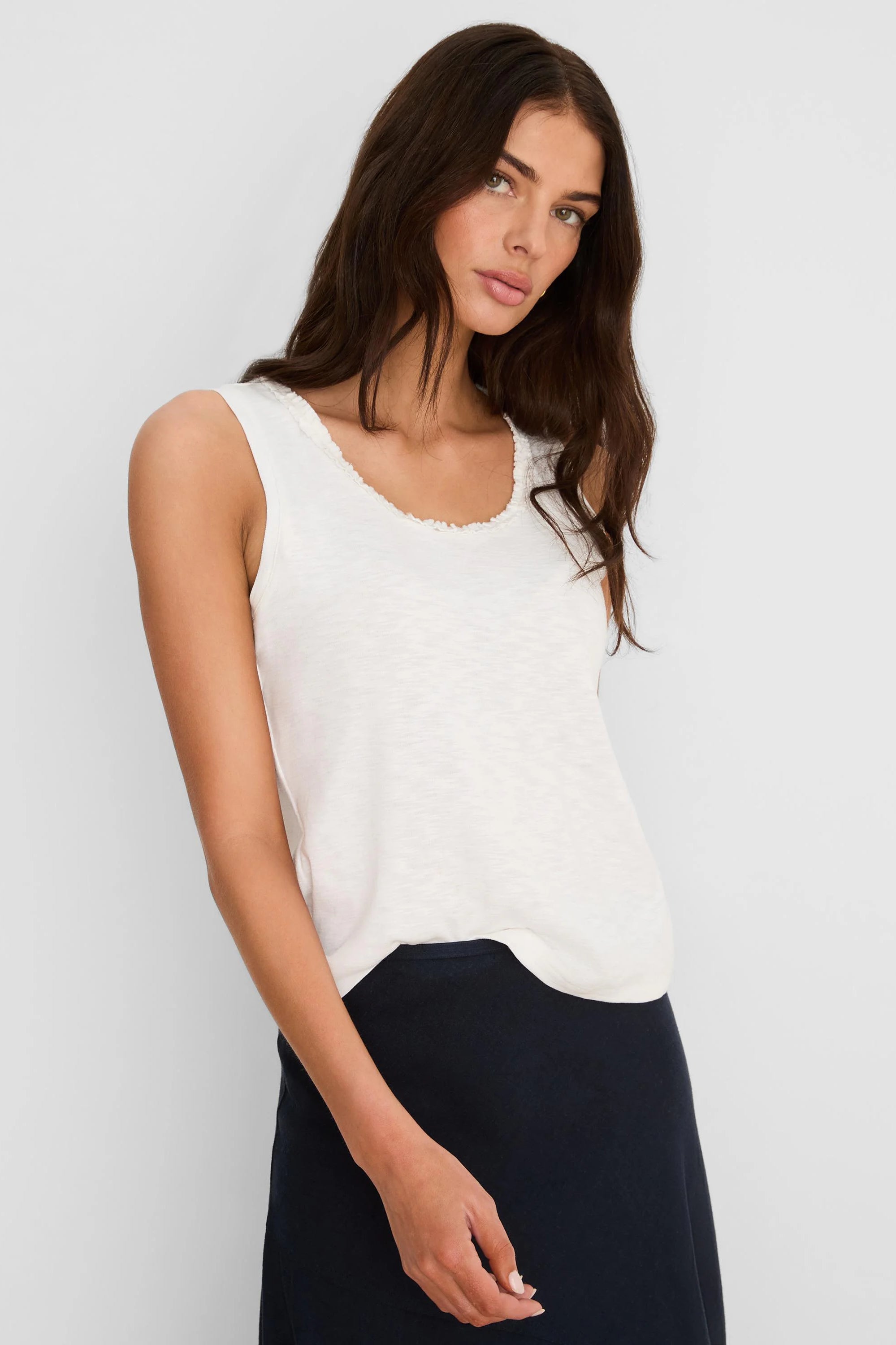 Cream cotton slub tank with a small ruffled neckline, worn by a model.
