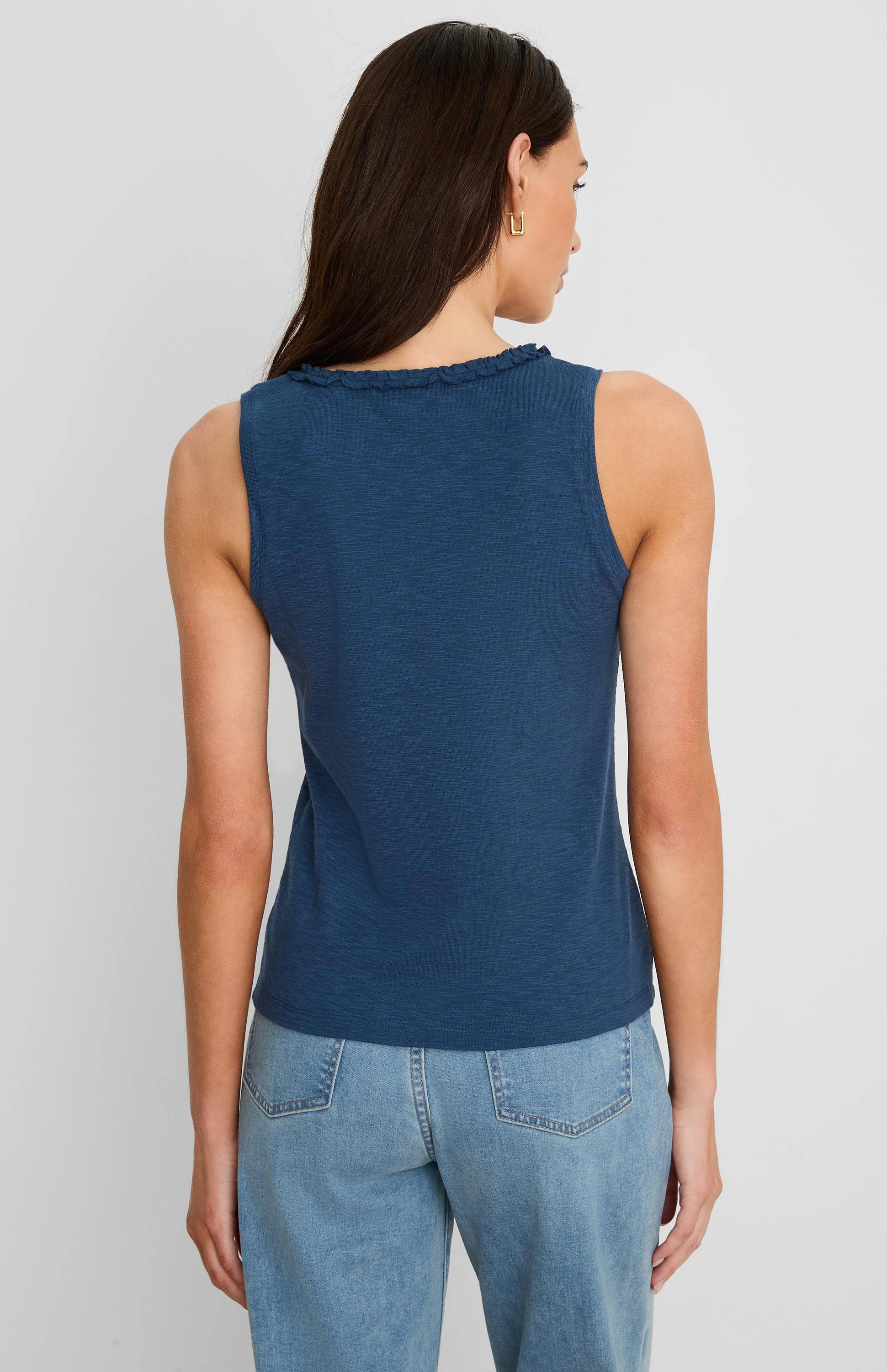 Back of a slate blue cotton slub tank top with ruffled neckline.