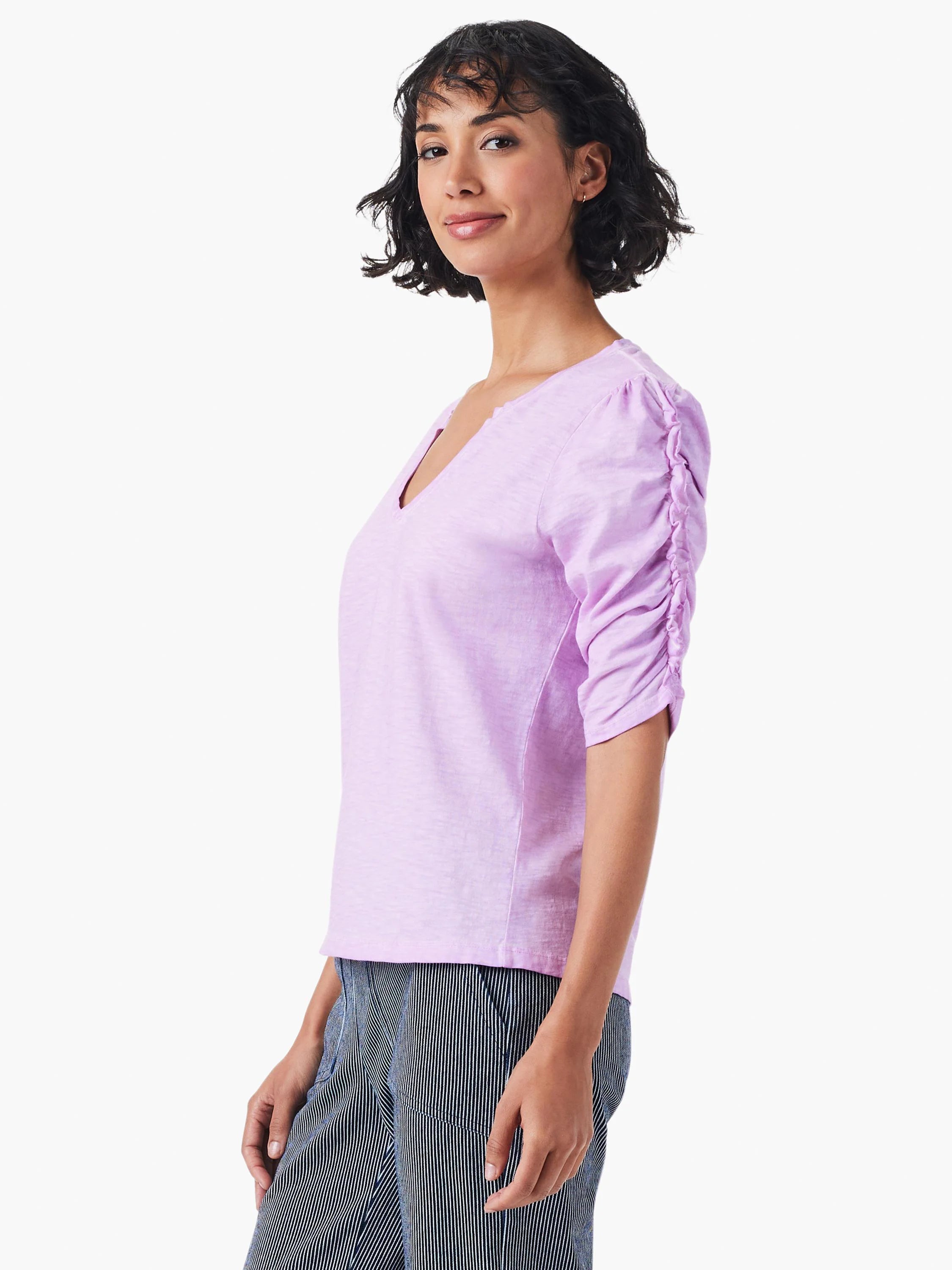 Lilac-colored top with elbow-length sleeves, ruched detailing on the sleeves and a split V-neck.