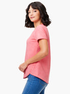 Washed pink short-sleeve tee with white shoulder stitching and a curved 'shirt tail' hem.