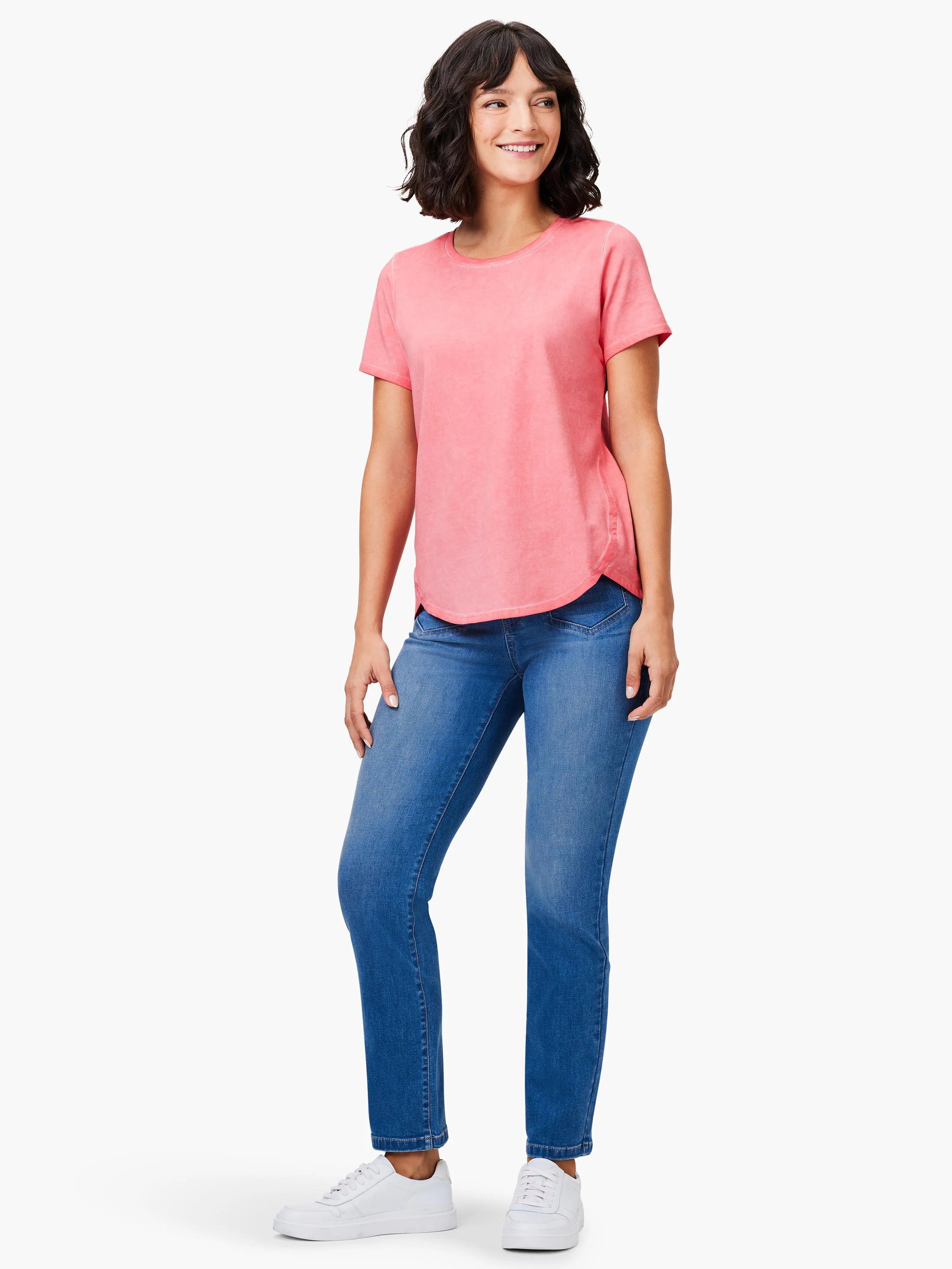 Faded pink short sleeve crew neck tee with a curved shirt tail hem, worn by a smiling woman.