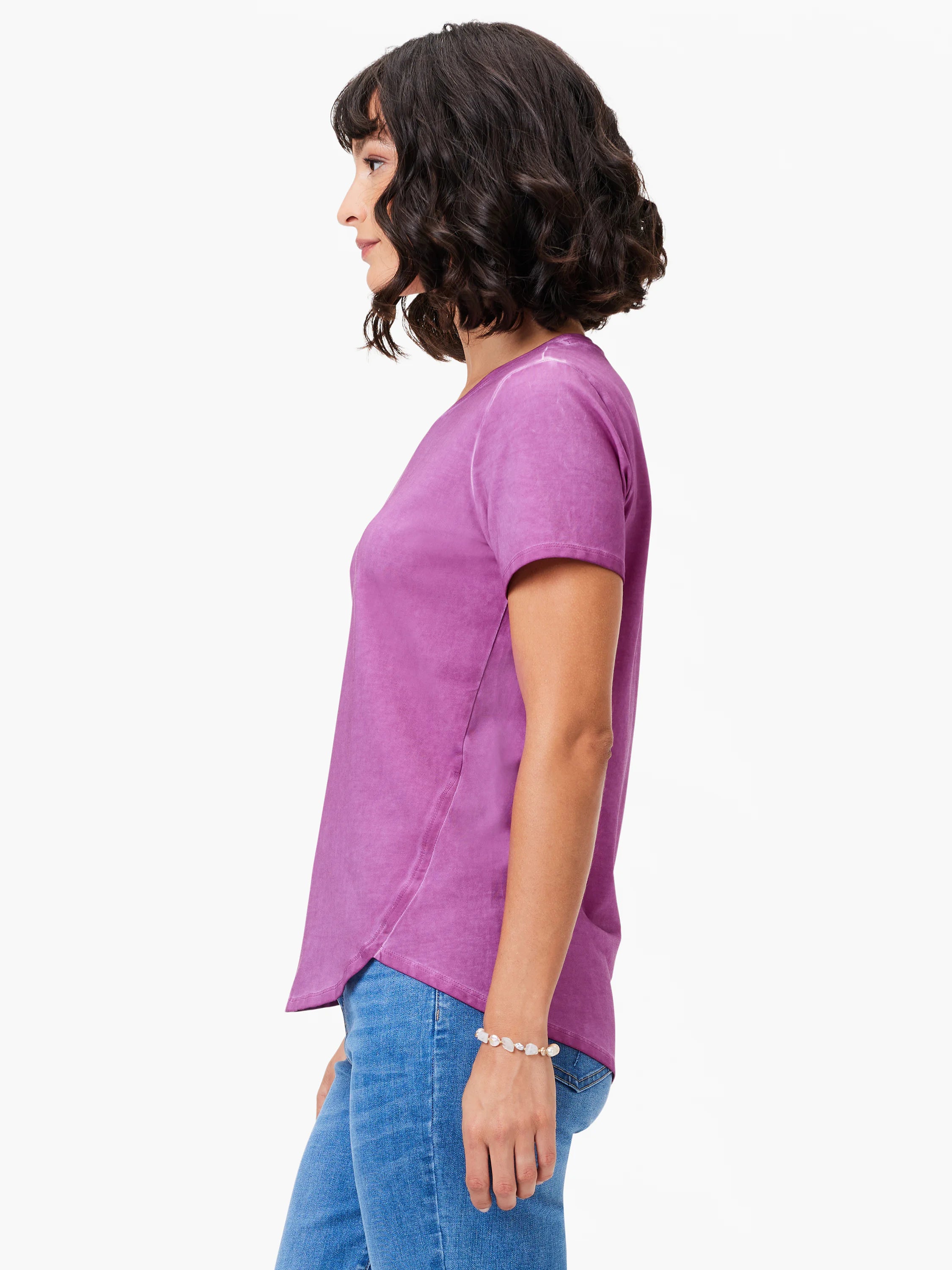 Washed plum short sleeve crew neck tee with a curved shirt tail hem, worn by a model.