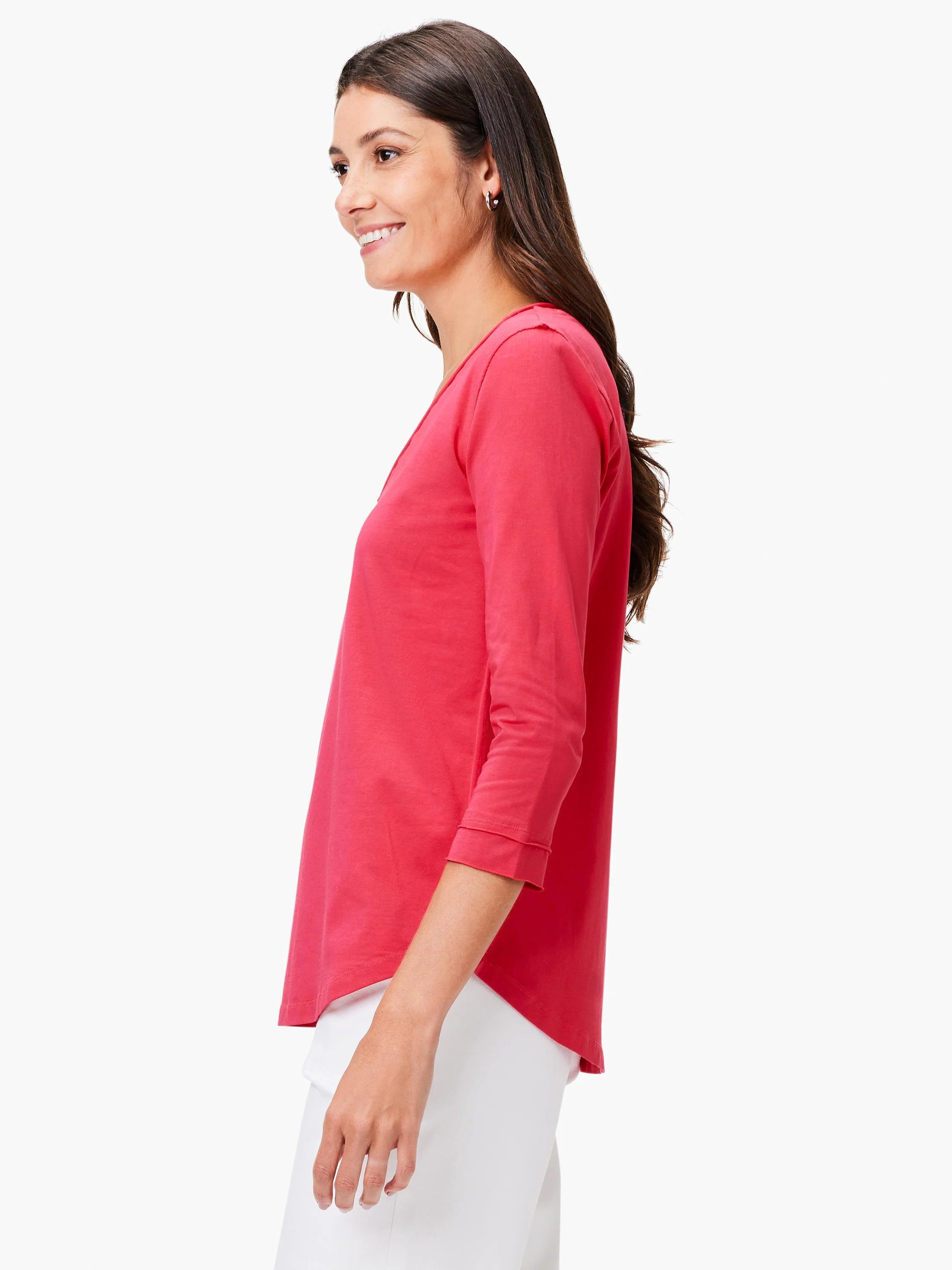 Coral V-neck 3/4 sleeve tee with rolled cuffs on a woman.