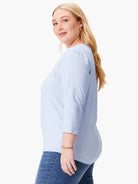 Light blue V-neck tee with 3/4 length rolled sleeves.