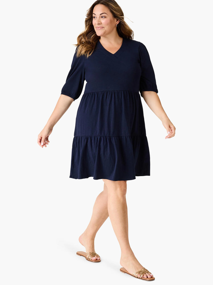 Navy blue tiered V-neck dress, short sleeves, above-knee length.