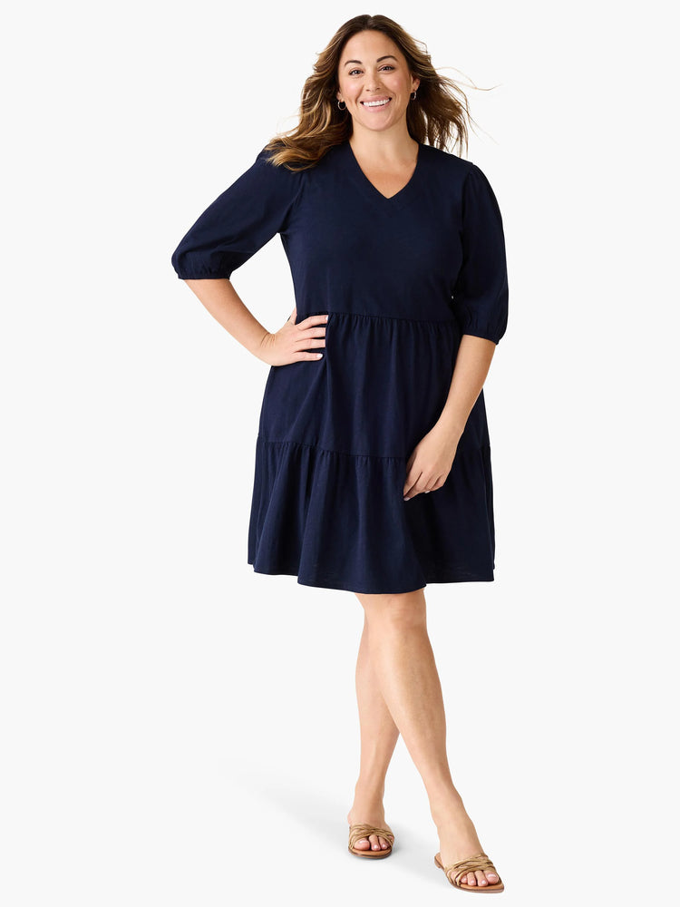Navy blue tiered V-neck dress, 3/4 sleeves, slightly puffed at the shoulders.