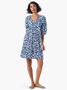 Tiered V-neck mini dress in blue, white, and dark teal abstract print.  Three-quarter sleeves.