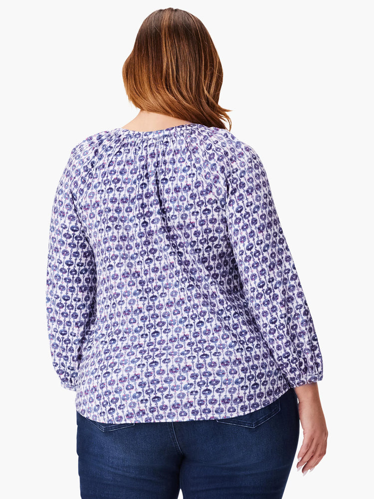 3/4 sleeve top, white background with purple and blue medallion pattern. Split neckline.
