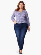 Purple and white patterned 3/4 sleeve top, v-neck.  Paired with dark wash jeans.