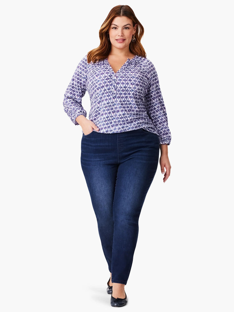 Purple and white patterned 3/4 sleeve top, v-neck. Paired with dark wash jeans.