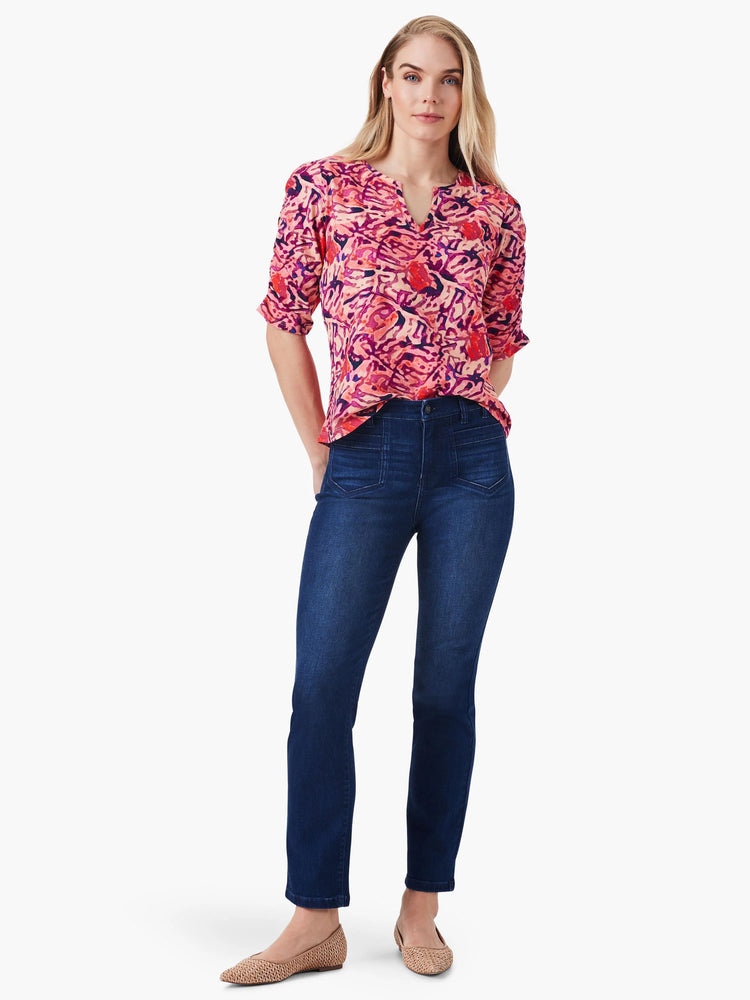 Pink floral elbow-sleeve top with ruched detail, V-neck. Paired with dark wash jeans.