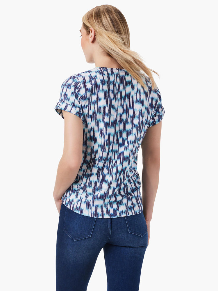 Image of short-sleeved split-neck tee. Teal, blue, and white abstract print on a white background. Short sleeves with...