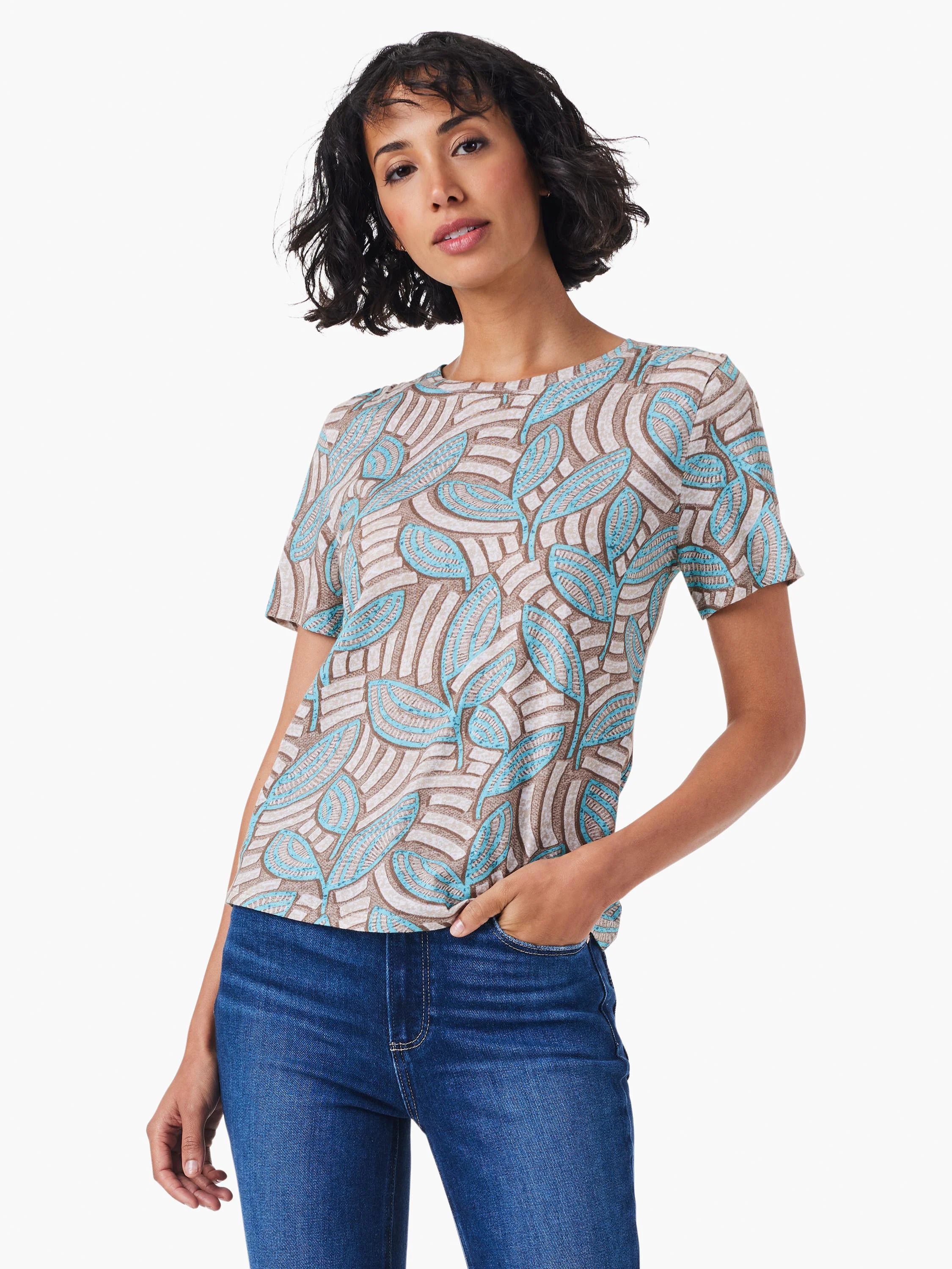 Short-sleeved crew neck tee. Taupe background with teal leaf pattern.