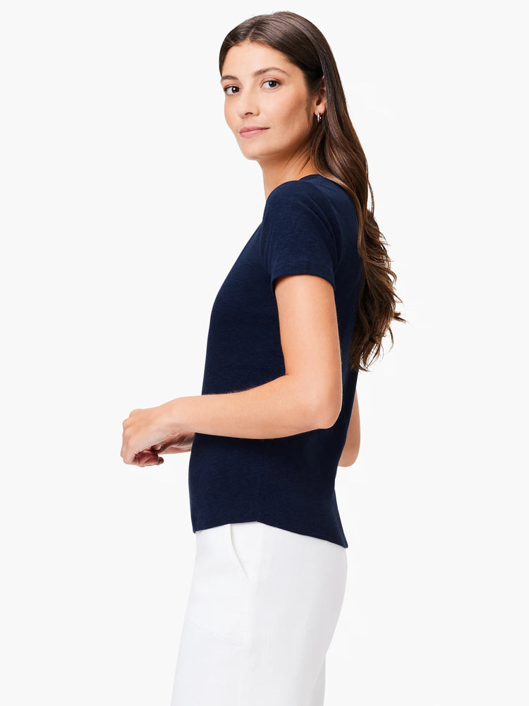 Image shows a navy blue, short-sleeved scoop-neck T-shirt on a model. The shirt appears to be a textured knit fabric.