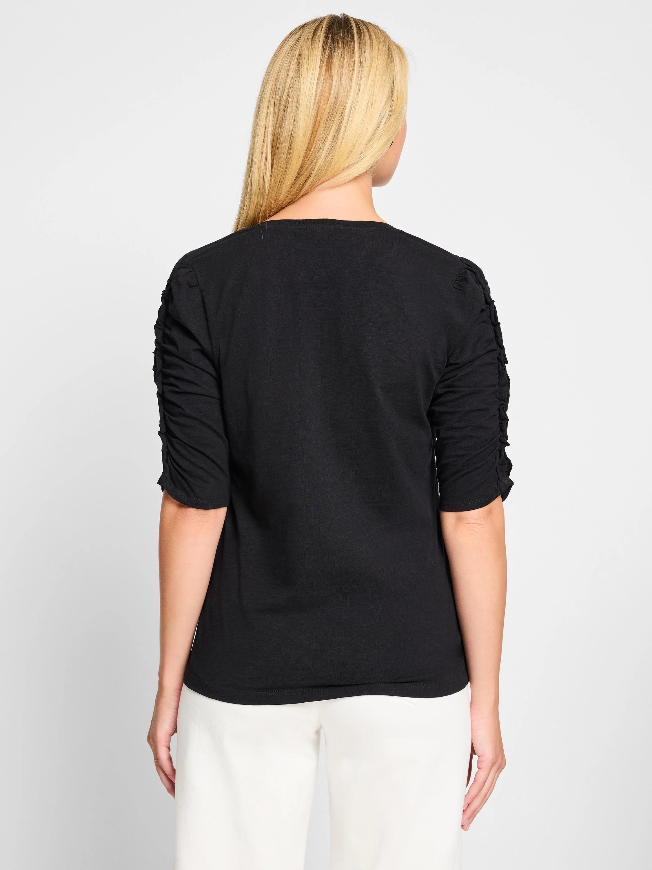 Black, elbow-sleeve t-shirt. Ruched sleeves, split neckline. Shown from the back.