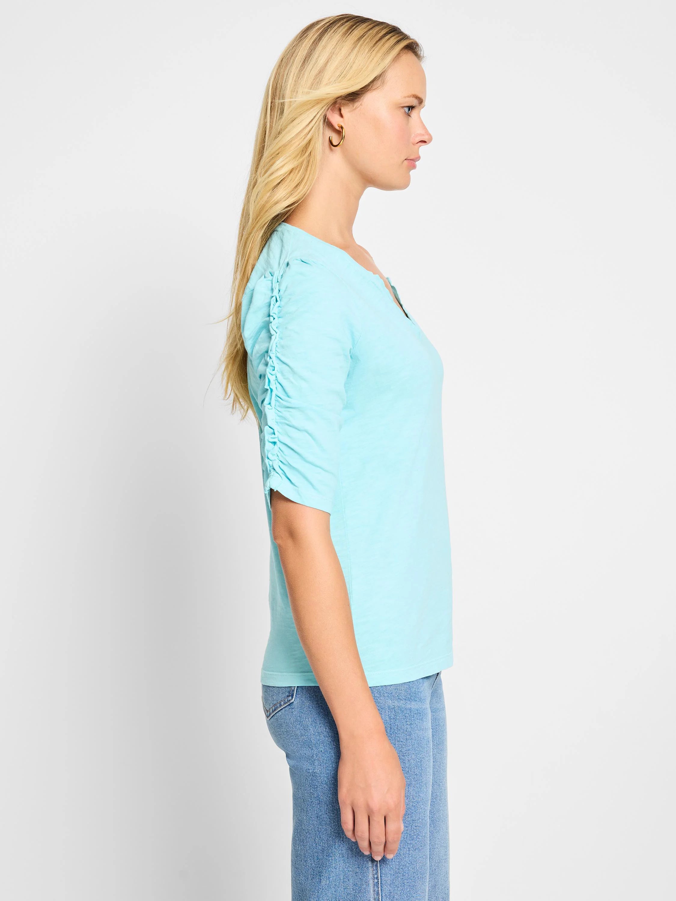 Light blue, short-sleeved t-shirt. Ruched sleeves, split neckline.