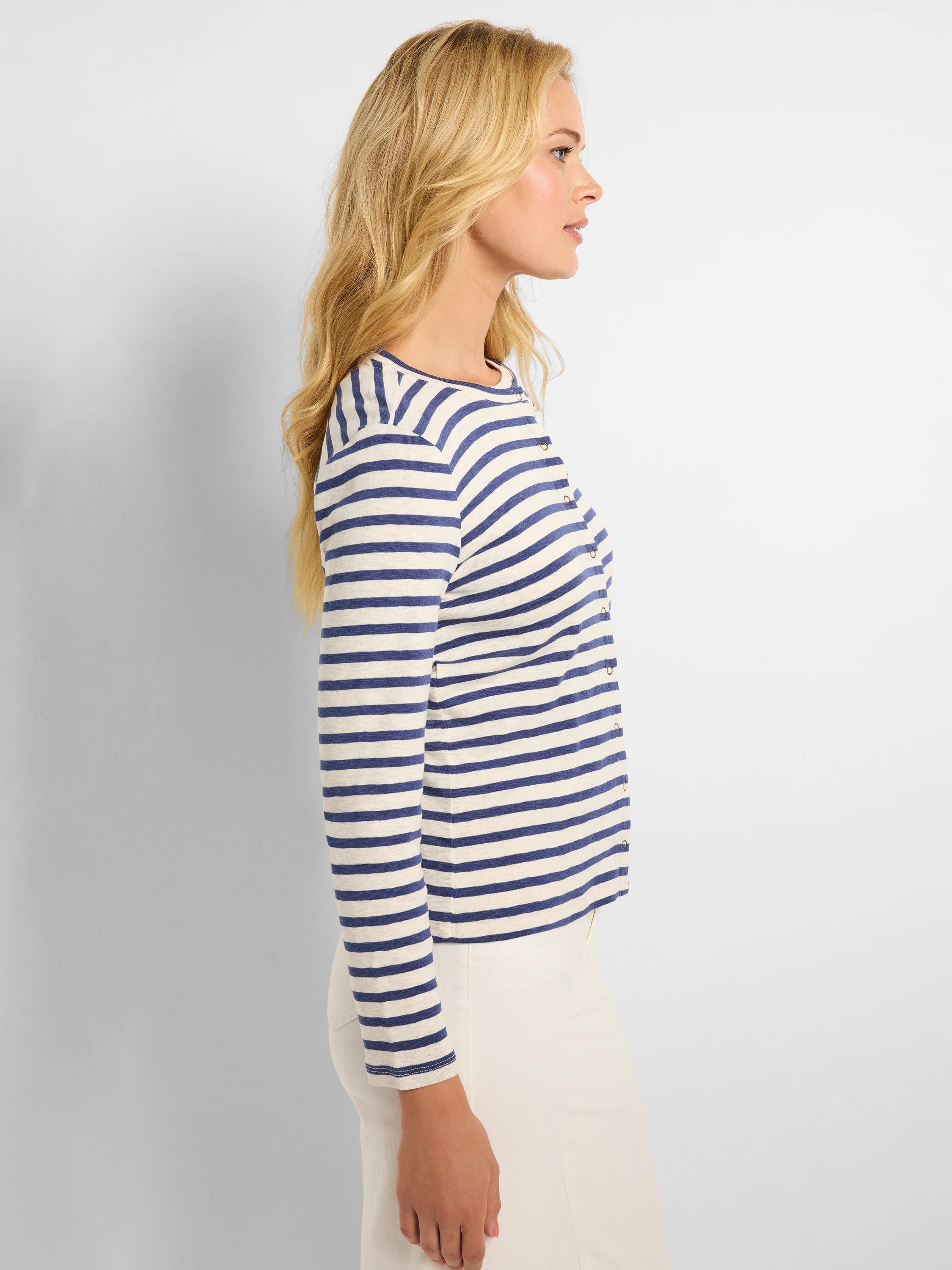 Here's alt text that meets the requirements:
Cream and navy blue horizontally striped cardigan, snap front, long sleeves.