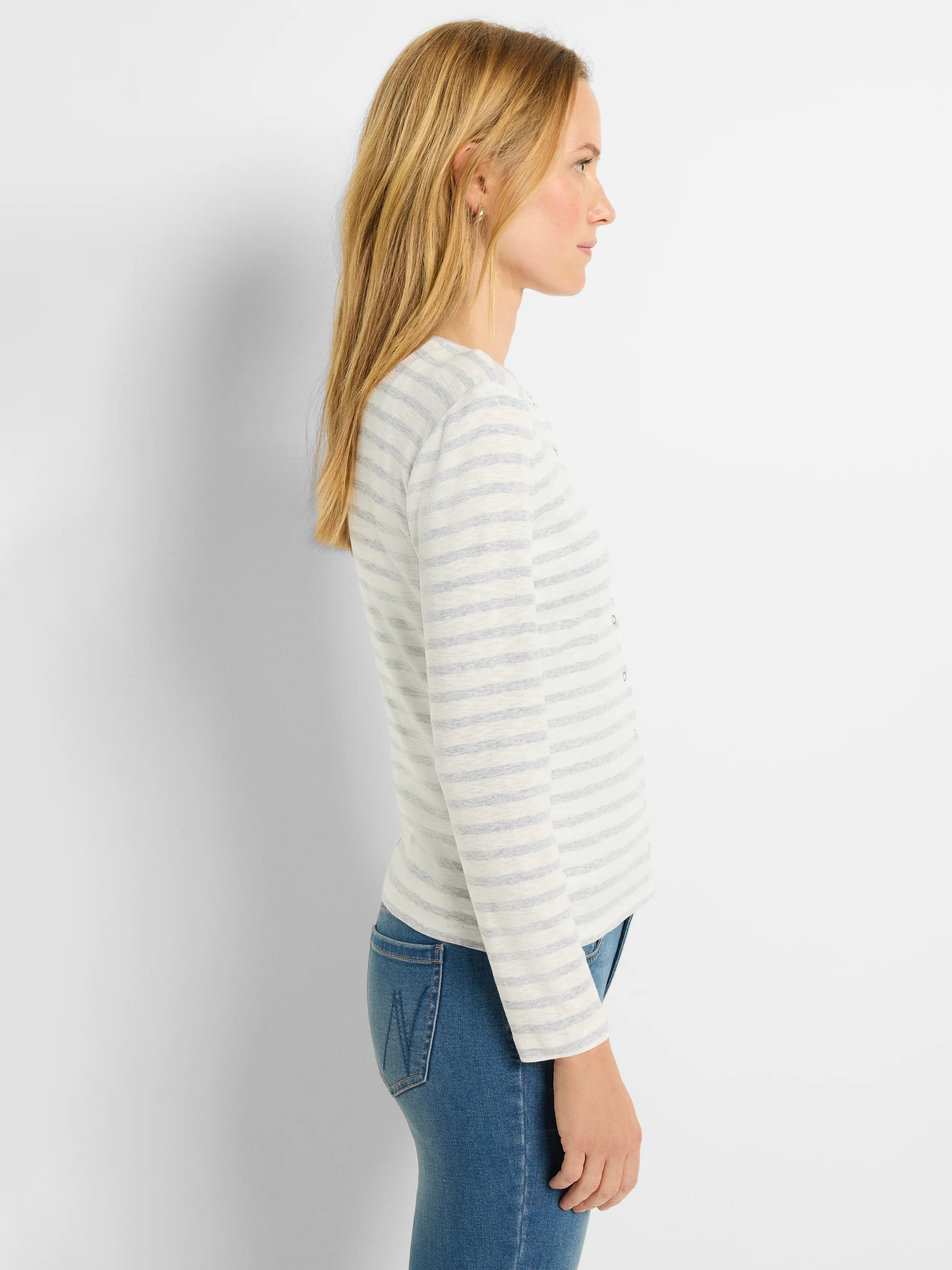 Off-white cardigan with thin, light-blue horizontal stripes, long sleeves, and snap front closure.