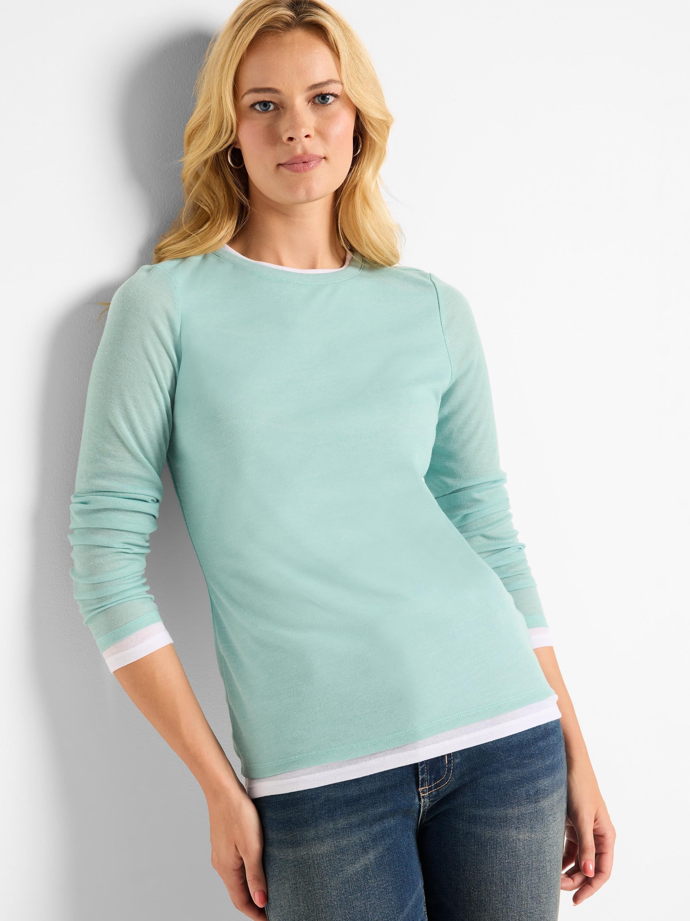 Light teal long-sleeve shirt, double layered with white trim at cuffs and hem.