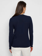 Navy blue long-sleeve henley with textured fabric and scalloped hem.