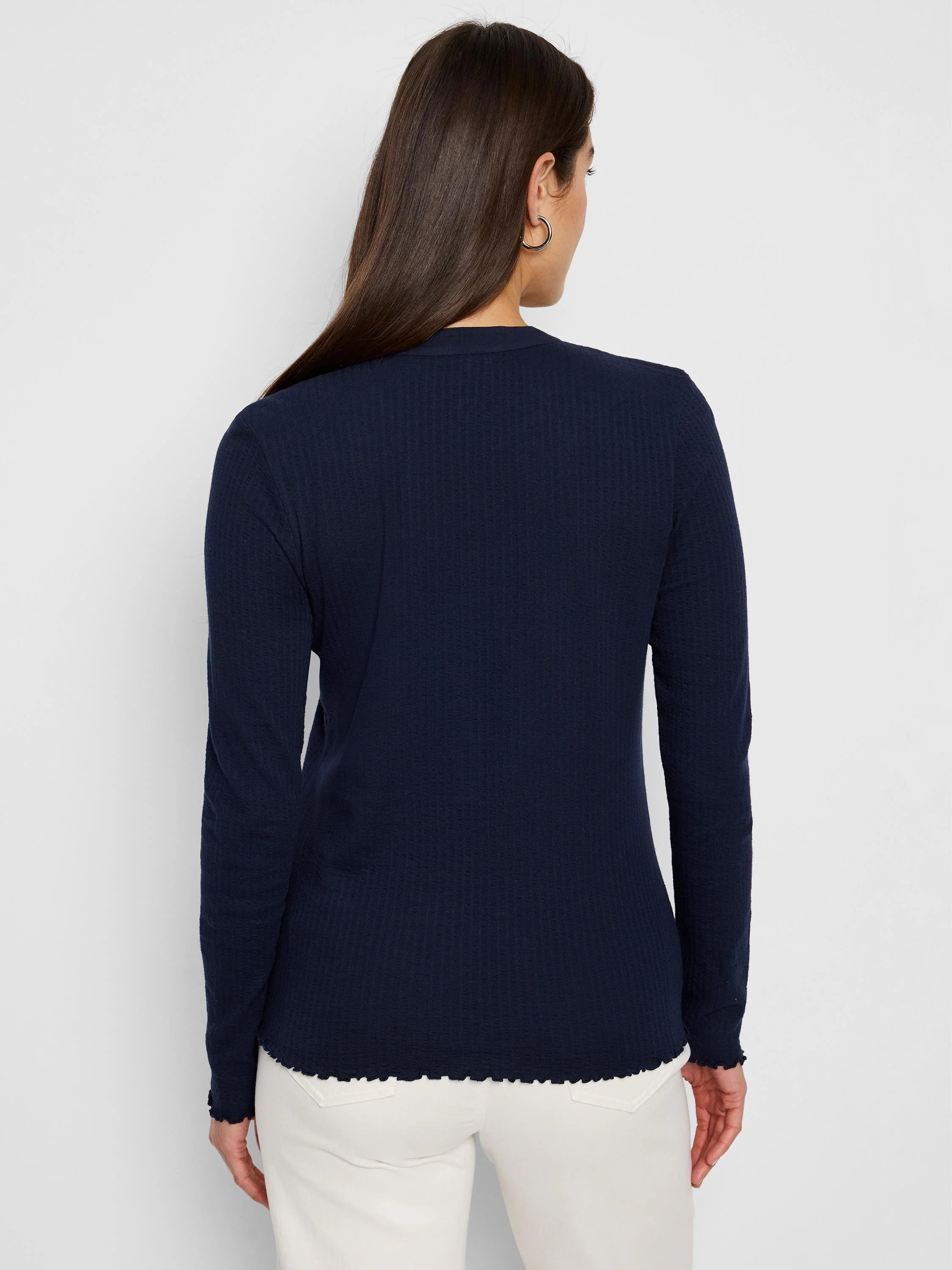 Navy blue long-sleeve henley with textured fabric and scalloped hem.