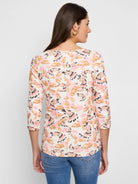 Off-white 3/4 sleeve shirt.  Pink, orange, & brown bird print.  Boat neck.