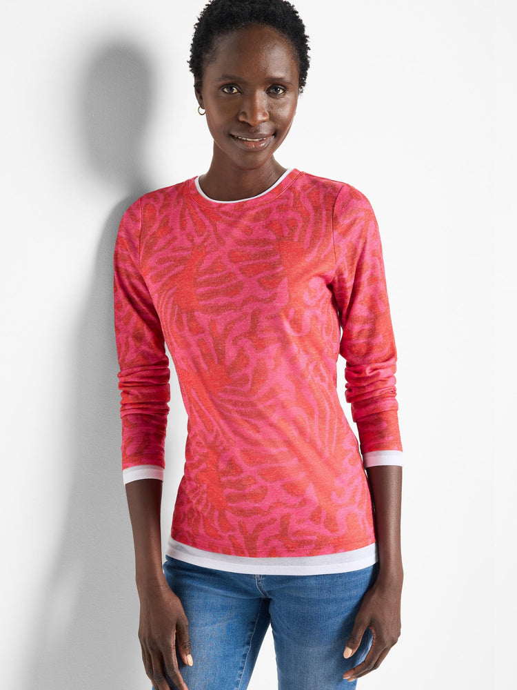 Pink long-sleeve top with a darker pink leaf pattern. Double layered at the cuffs and hem; white inner layer shows.