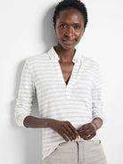 White long-sleeve polo shirt with thin gray stripes, v-neck.