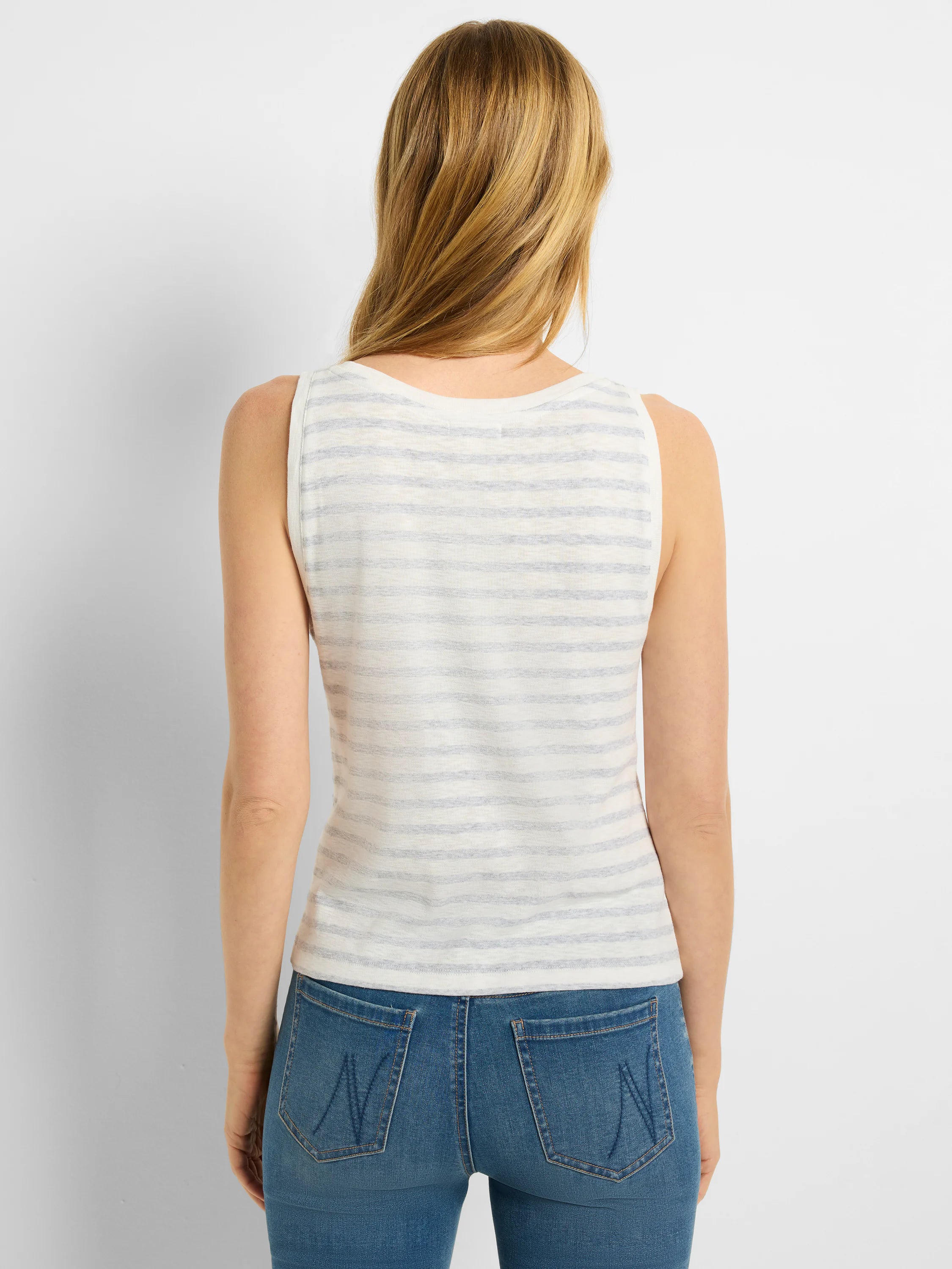 Here's alt text that meets the requirements:
"Back view of sleeveless, white tank top with thin, light blue stripes.