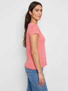 Coral pink, short-sleeved knit t-shirt with textured fabric and scalloped hem.