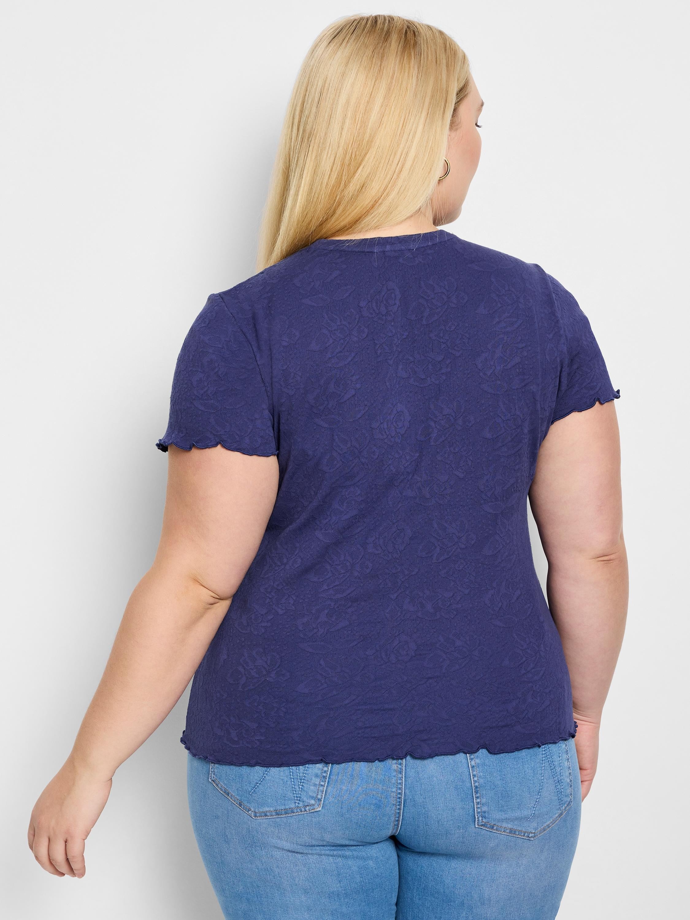 Dark blue, short-sleeved knit t-shirt.  Scalloped hem and textured floral pattern.