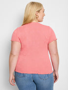 Coral pink, short-sleeve t-shirt with textured, lace-knit pattern and scalloped hem.
